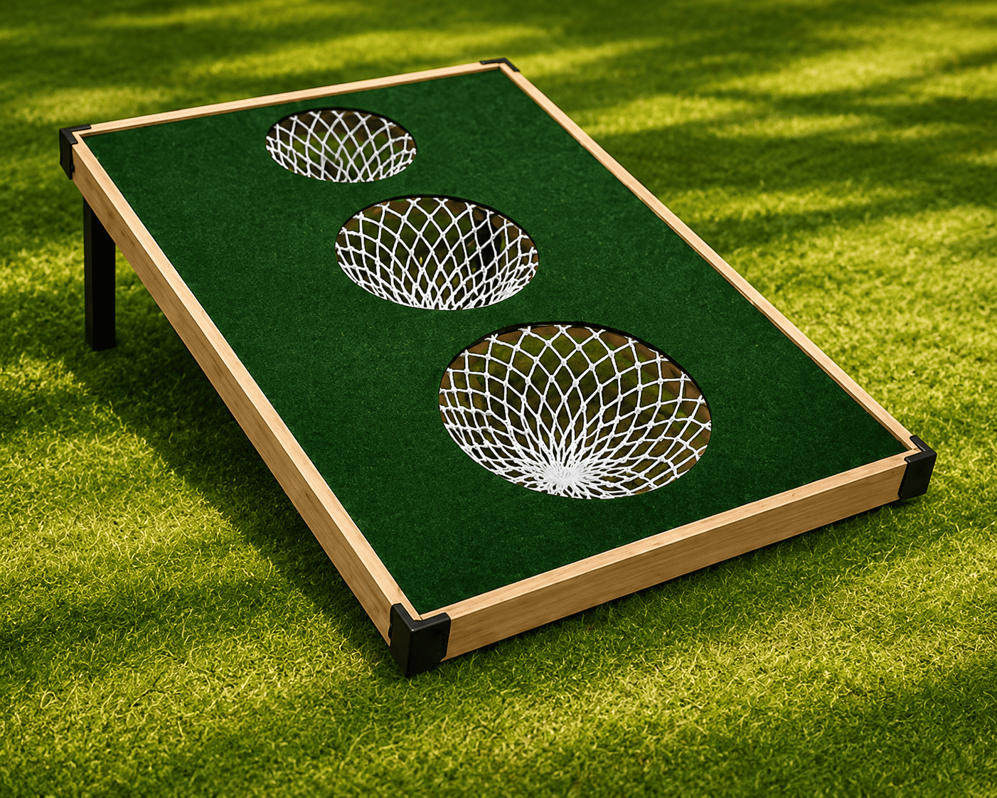 A mini basketball game set up on green artificial turf, with three hoops and nets aligned in a row, on a rectangular surface.