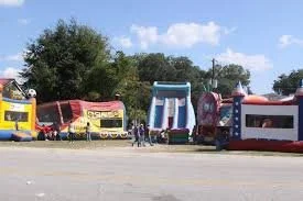 Row of food trucks with colorful exteriors parked outdoors.