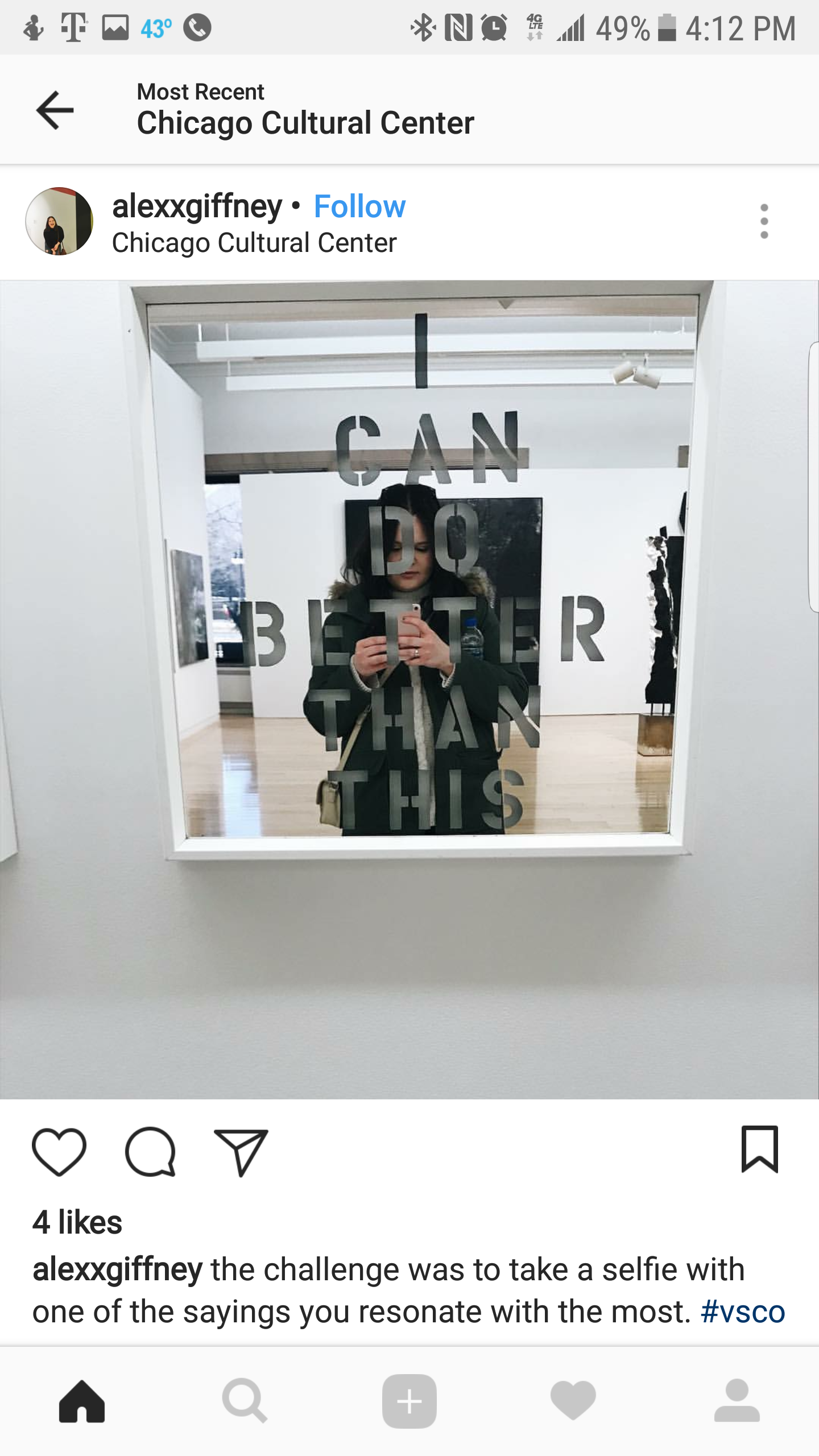 A woman taking a selfie in a mirror at the Chicago Cultural Center, with the quote 'I CAN DO BETTER THAN THIS' on the mirror