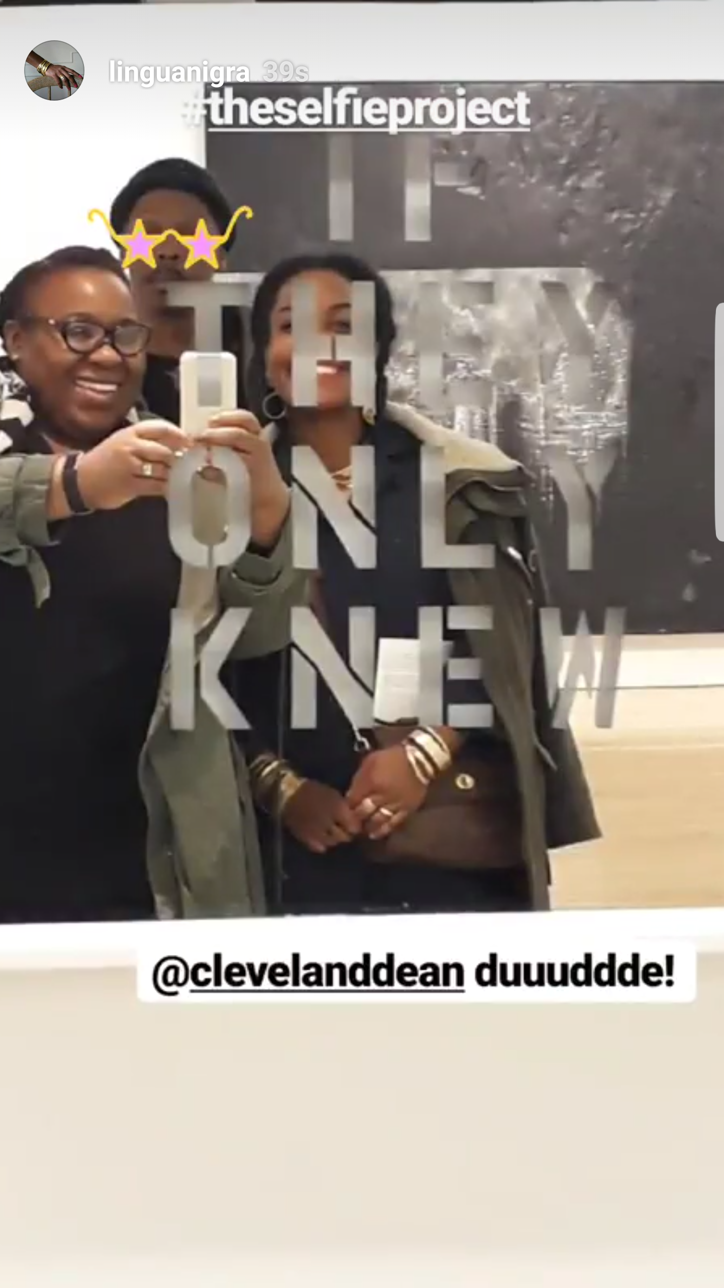 Three women and one person take a selfie on a glass door with the text '#theselfieproject' and '@clevelanddean duuudde!' written on it.
