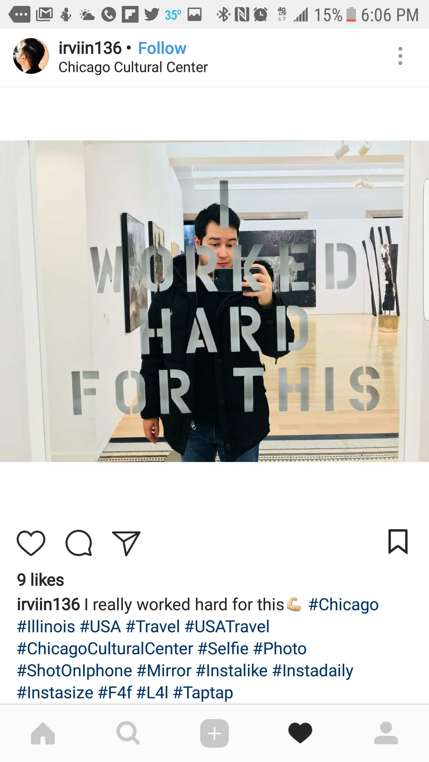 A man taking a mirror selfie inside the Chicago Cultural Center, with the reflection in the mirror showing a large text reading "WORK HARD FOR THIS".