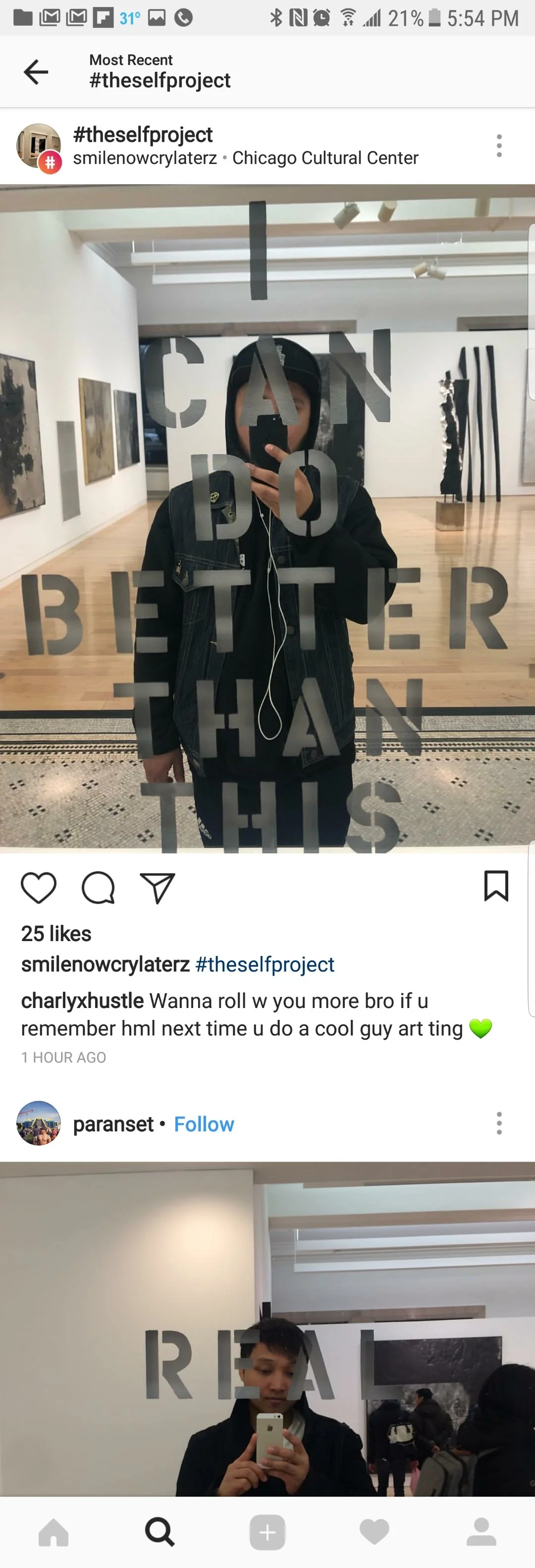 Reflection of a person in a glass door at an art gallery, with the words 'CAN DO BETTER THAN THIS' written on the glass.