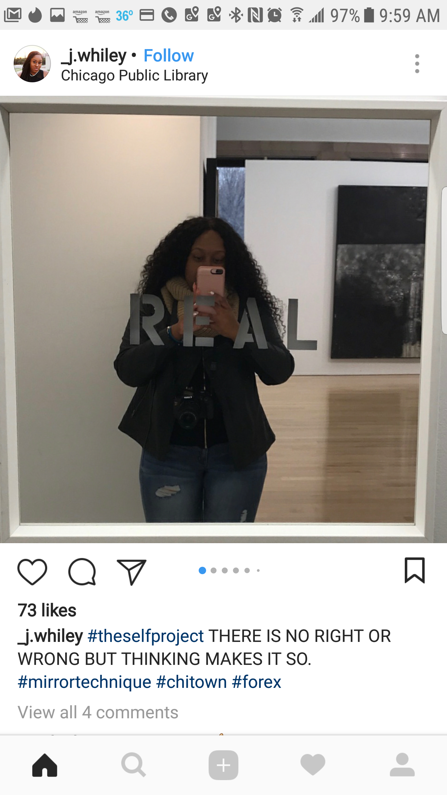 A woman taking a mirror selfie at the Chicago Public Library, wearing a black jacket and jeans with a camera around her neck.