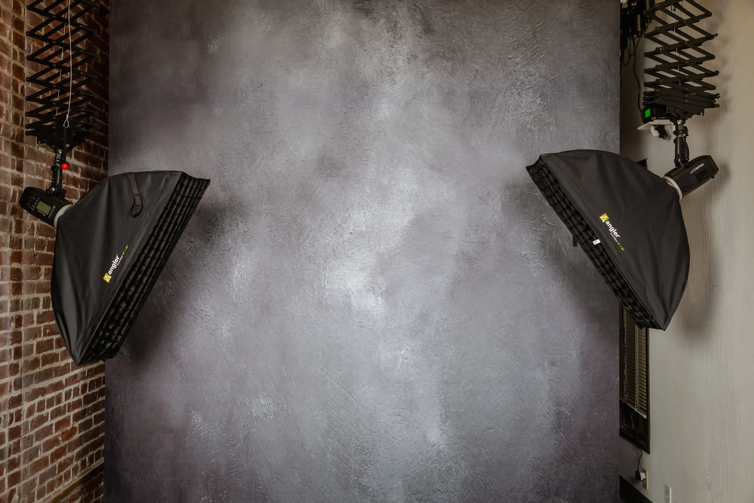 indoor studio space with gray backdrop and two strip lights on each side