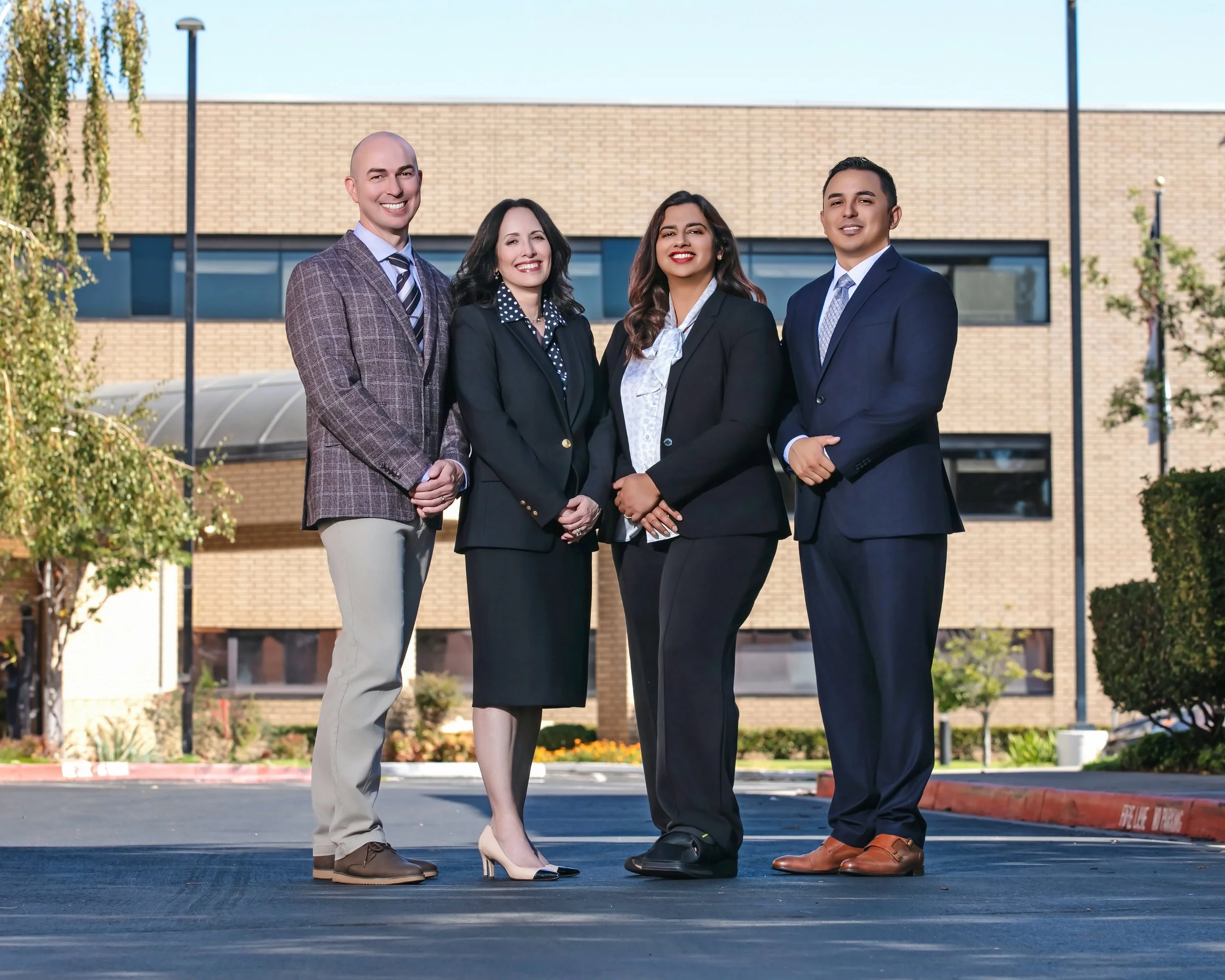 board of directors outdoors team photo in front of bay area hospital
