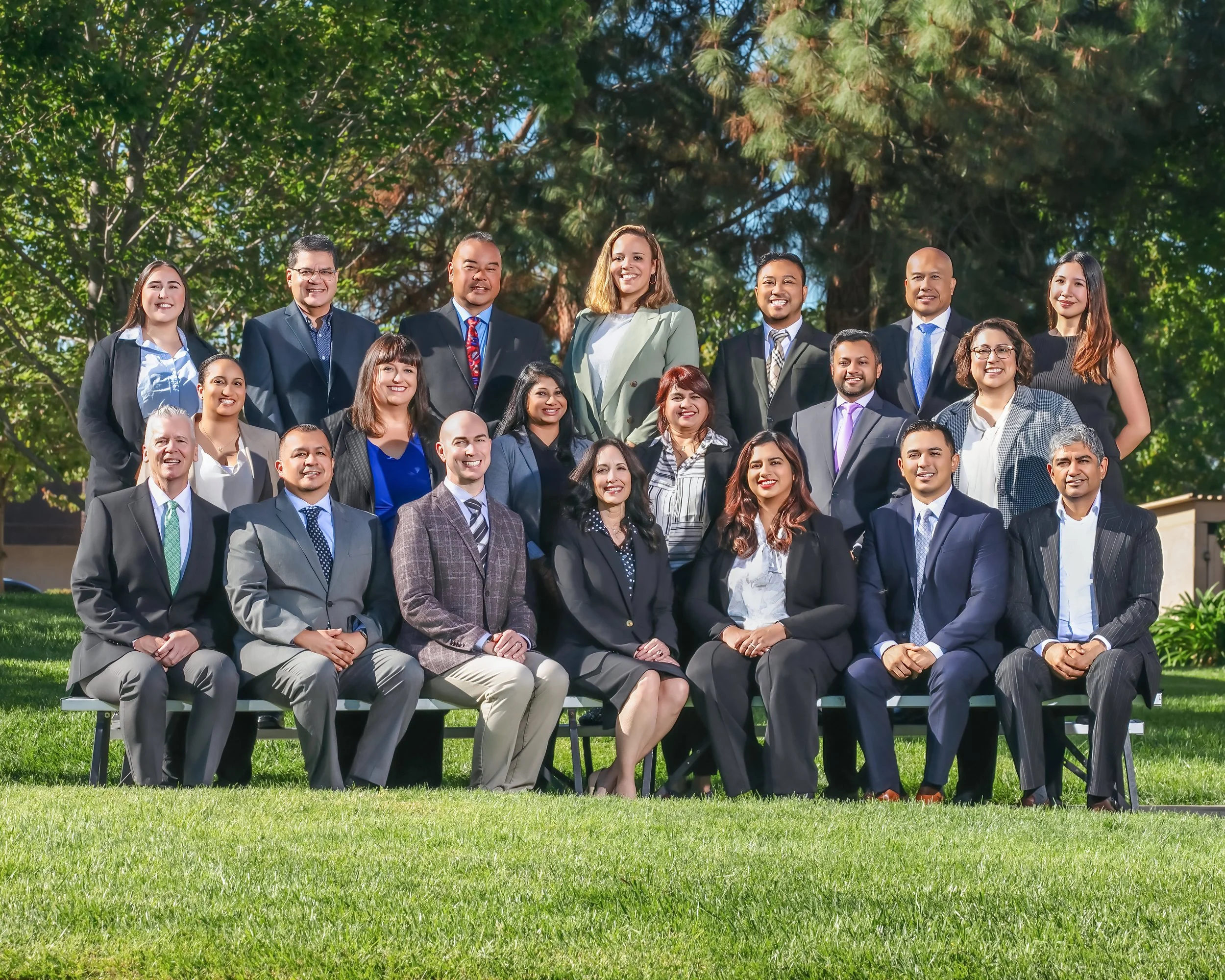 professional corporate team photo in natural outdoor campus.