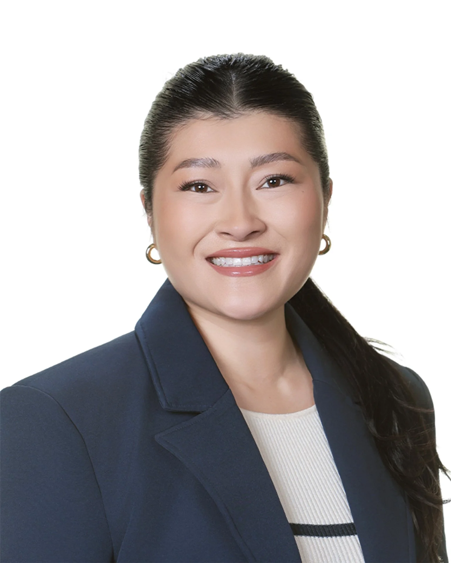 A female corporate worker wearing a navy blazer and a white blouse with gold hoop earrings, framed as a headshot on white background.