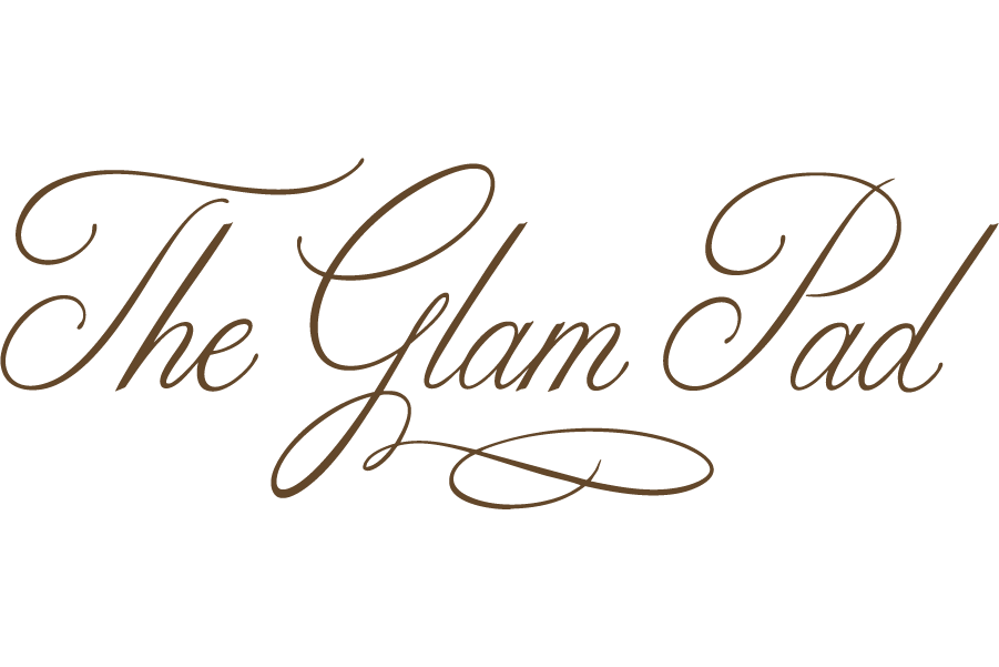 The logo of The Glam Pad in elegant, cursive brown font on a black background.