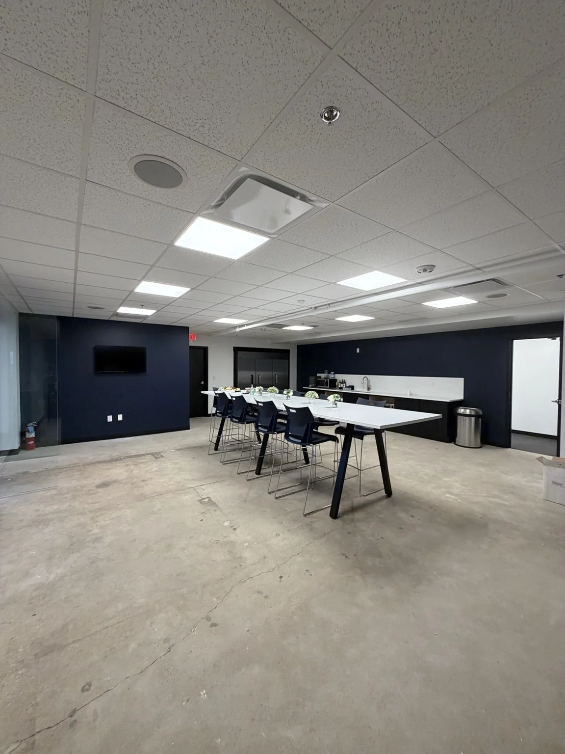 photo shows an employee break room and kitchenette with blue and white contrasting details