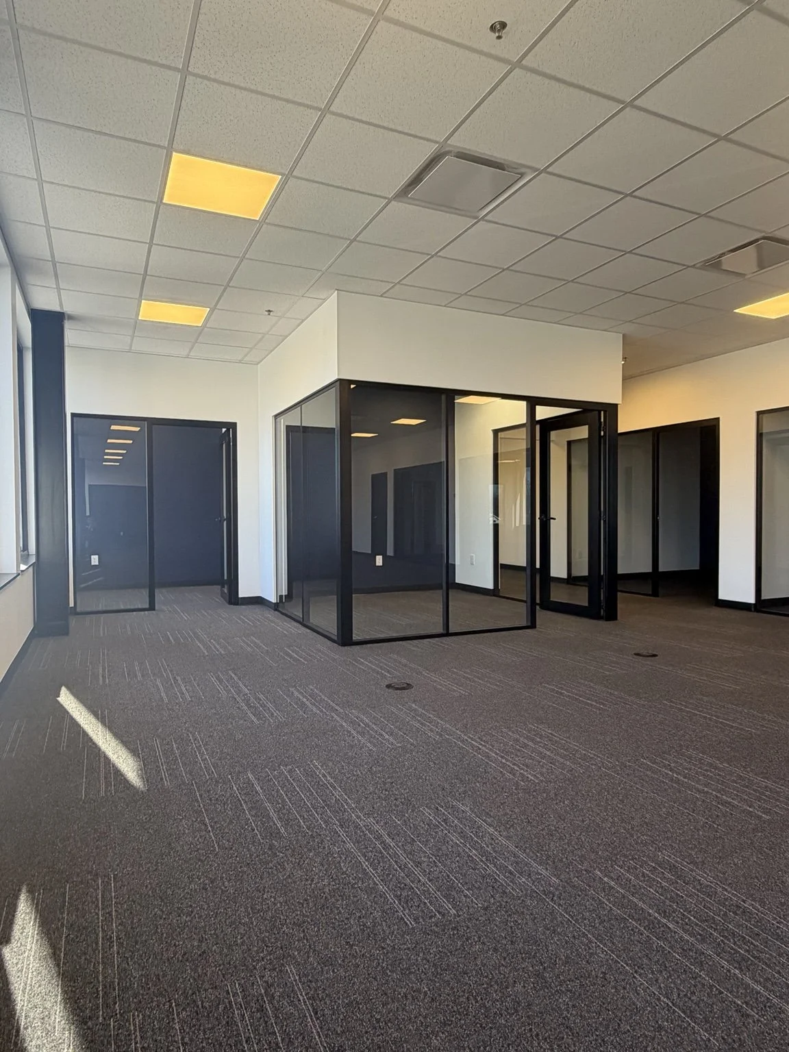 photo shows empty office spaces, these are full glass wall offices