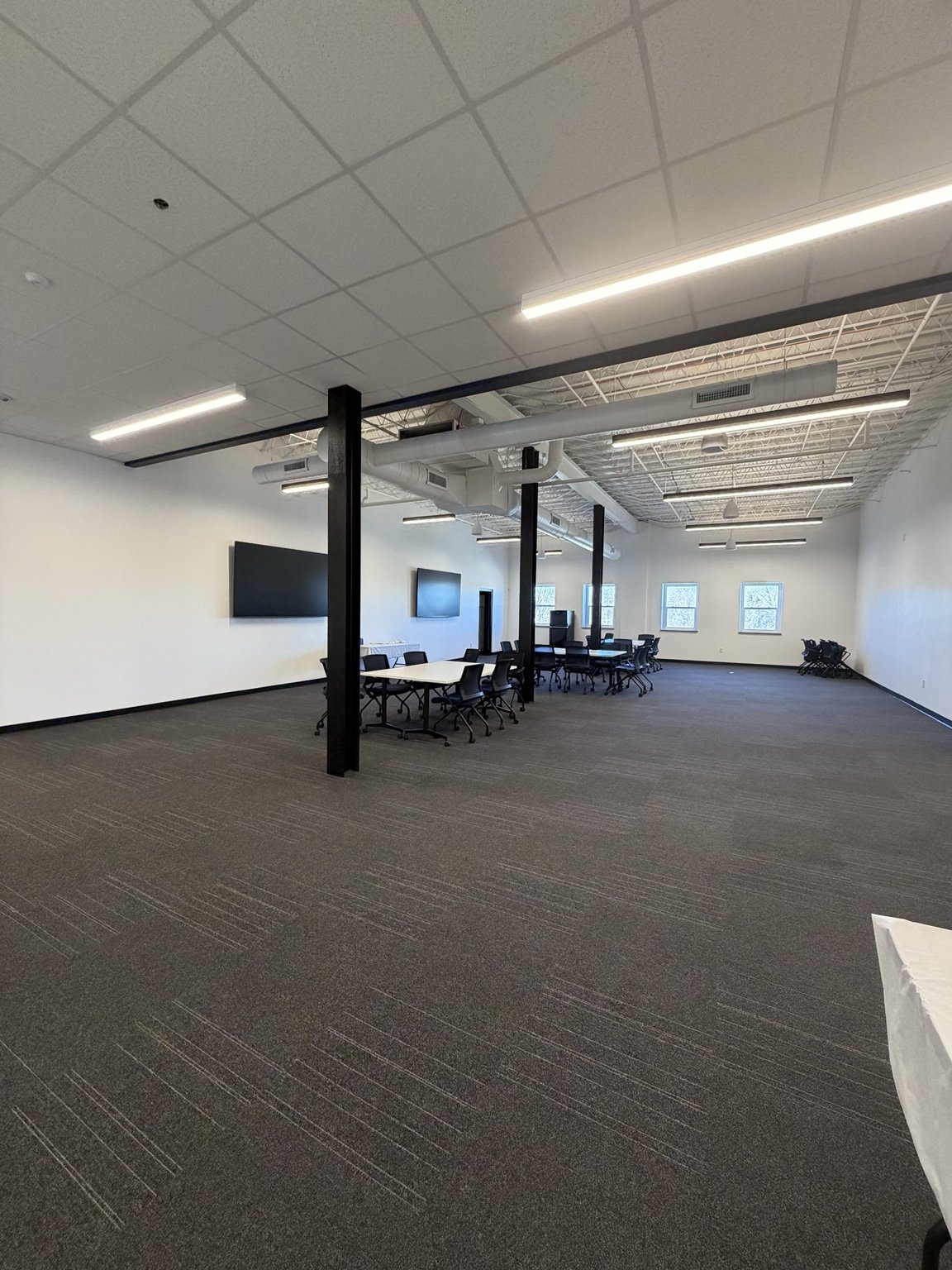 photo shows a large and airy collaborative workspace