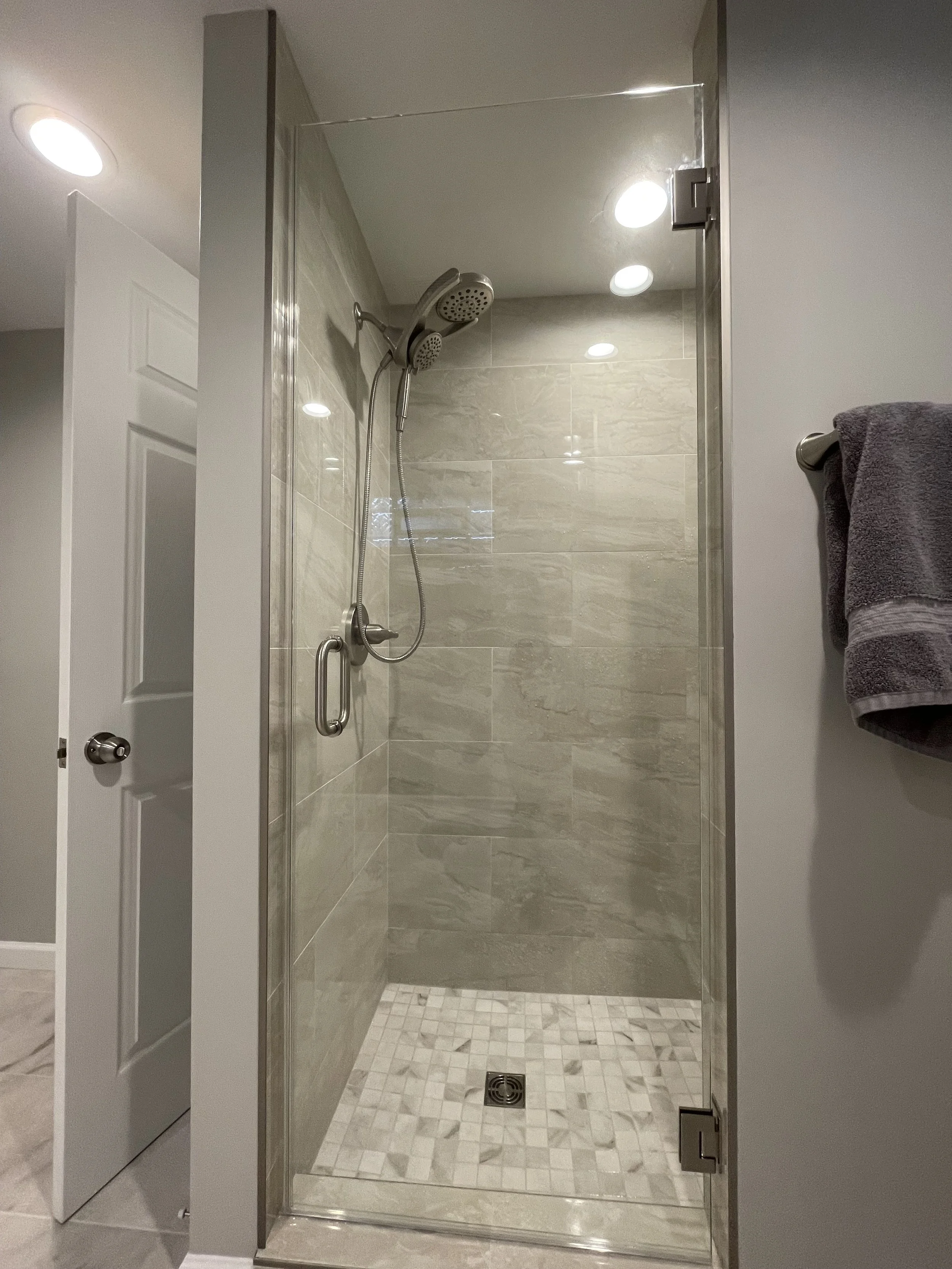 photo shows the inside tile work on the walk in shower -- a built in seat is at the back