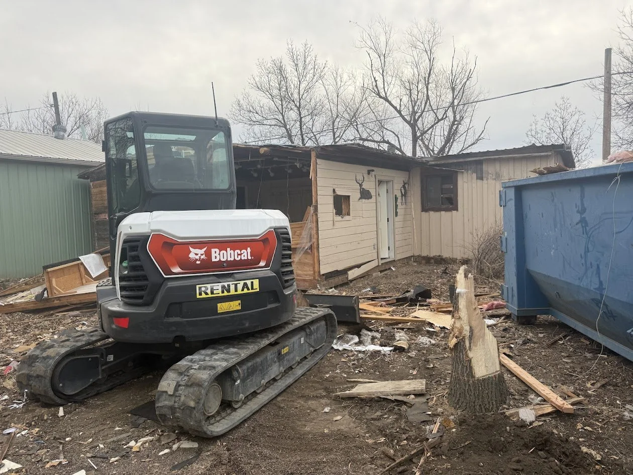 Excavator demolishing house 