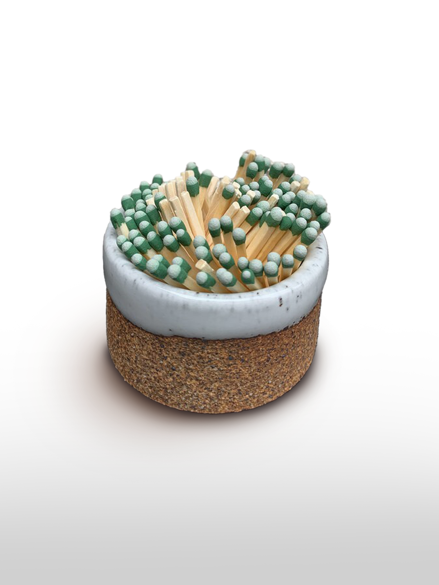 Handmade stoneware match striker with a raw orange-brown clay base, white glazed rim, and green-tipped matches inside.
