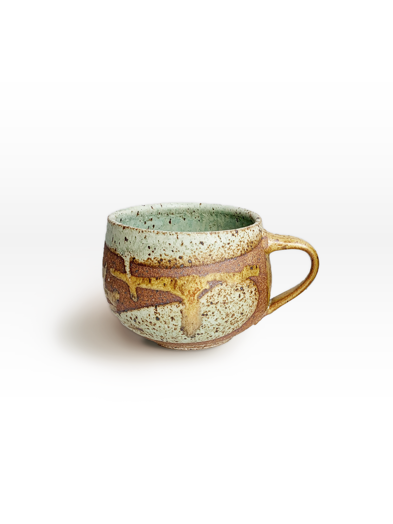Handmade round stoneware mug with a brown clay body, turquoise speckled glaze, golden tan glaze movement, and side handle.