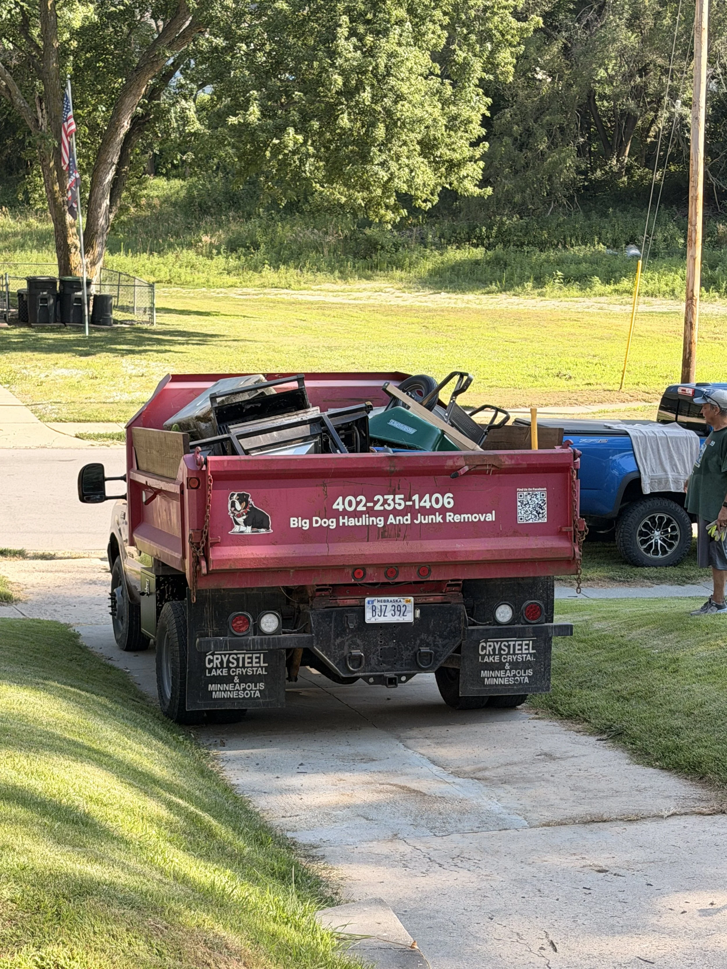 Big Dog Hauling and Junk Removal truck loaded with junk during a hauling job in Bellevue, Nebraska.