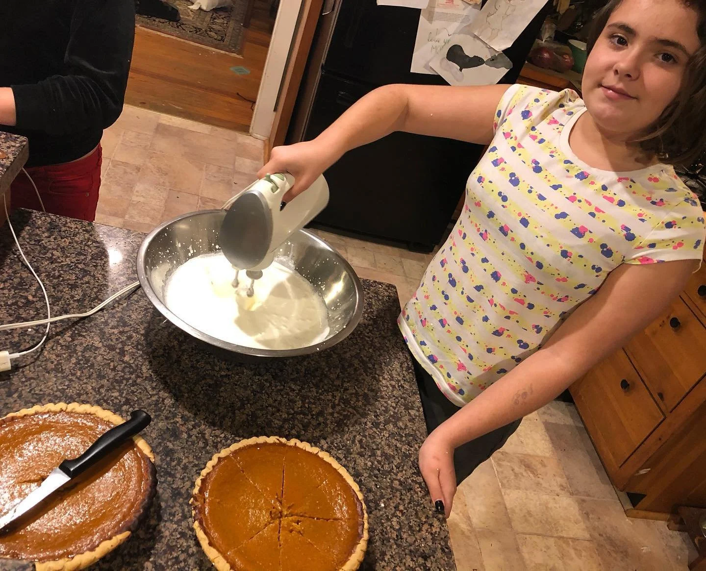 A young person making a pie.