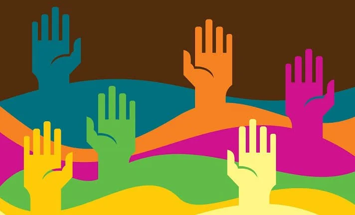 Colorful abstract illustration of multiple raised hands of various colors against a multicolored background.