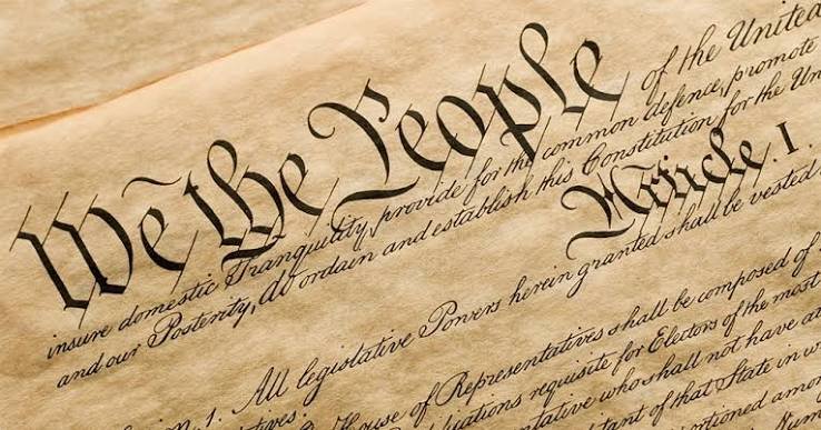Close-up of the United States Constitution with the heading 'We the People' in large calligraphy.