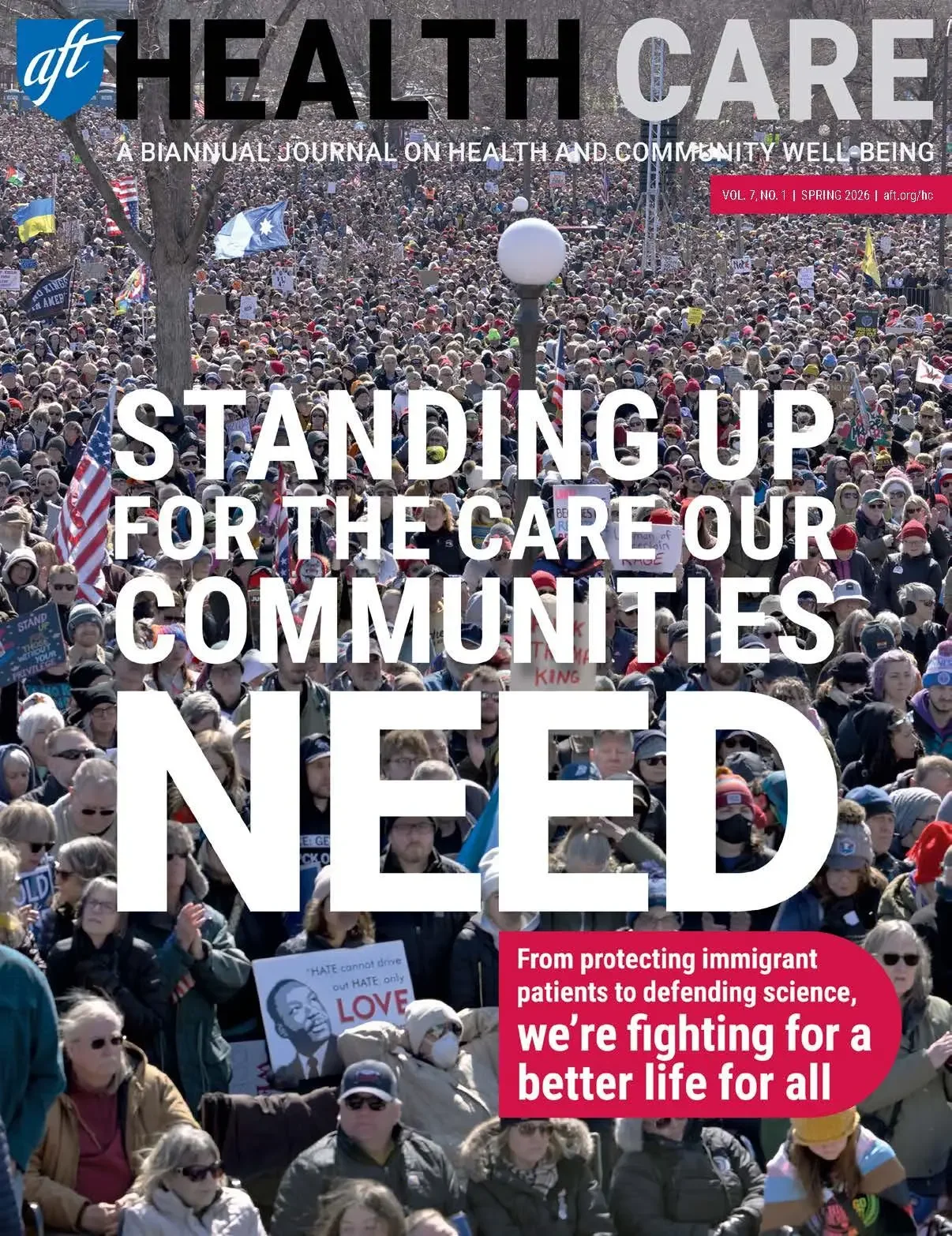 Cover of a magazine featuring a large crowd of people participating in a rally or protest, holding signs and flags, with a headline that reads 'Standing Up for the Care Our Communities Need' and an additional red banner with text about fighting for a better life for all.