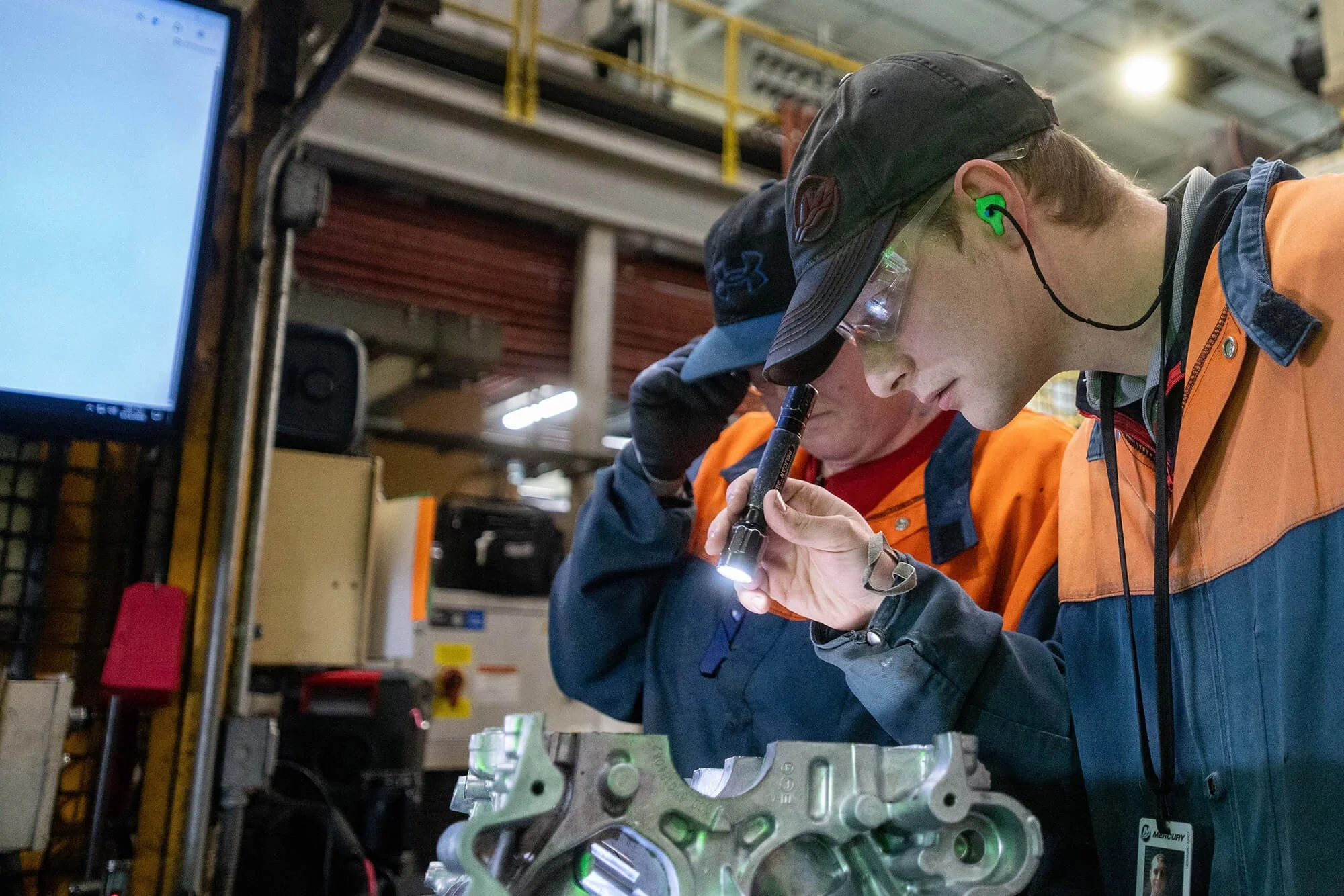 Manufacturing professional inspecting a precision metal casting.