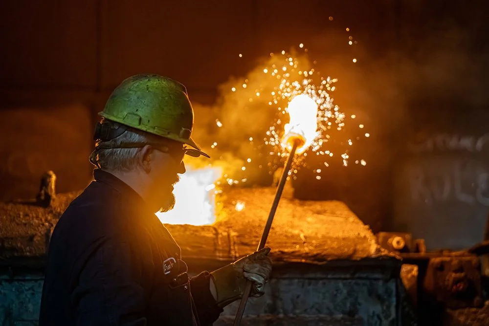Foundry worker using a torch inside a modern metalcasting facility.