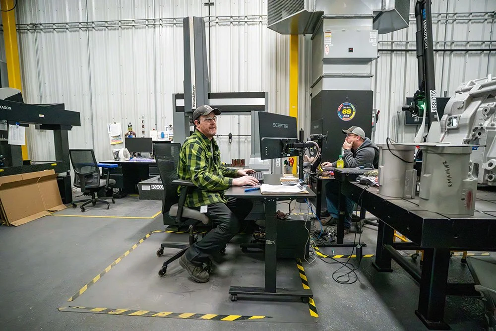 Manufacturing engineers collaborating inside a modern production facility.