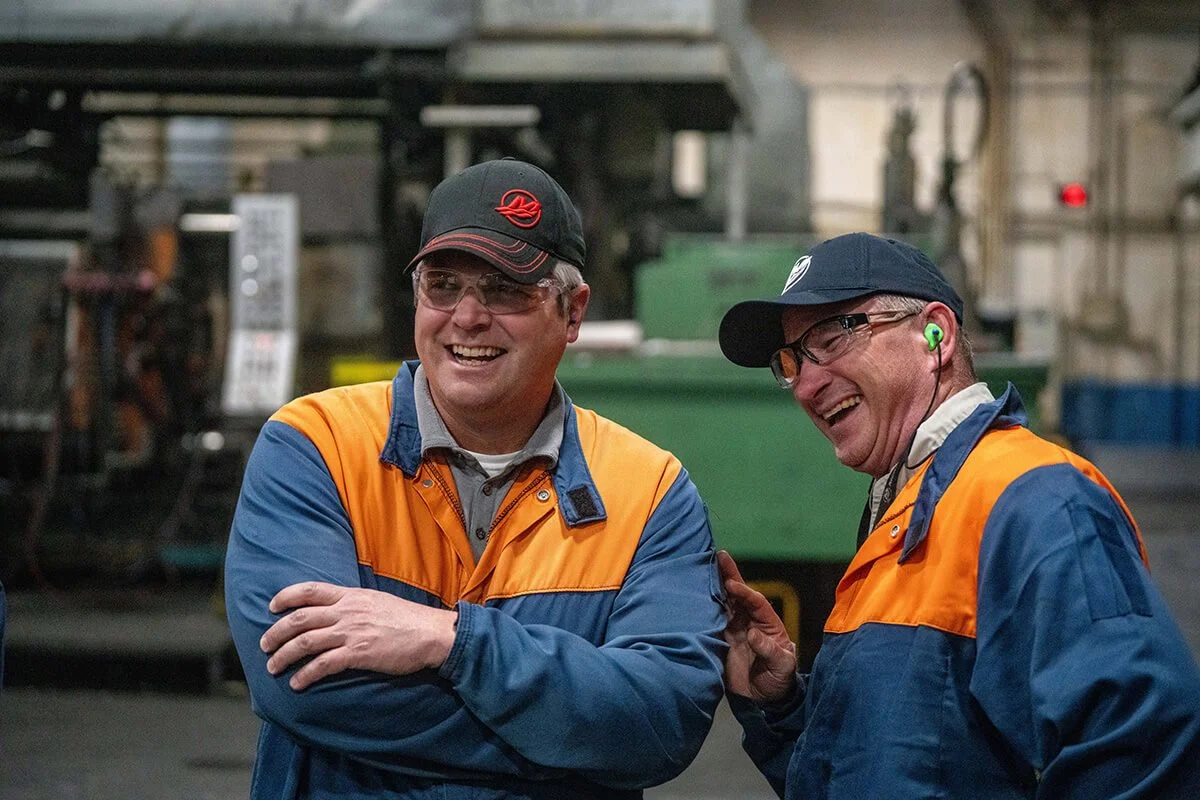 Two manufacturing professionals working together on the shop floor.