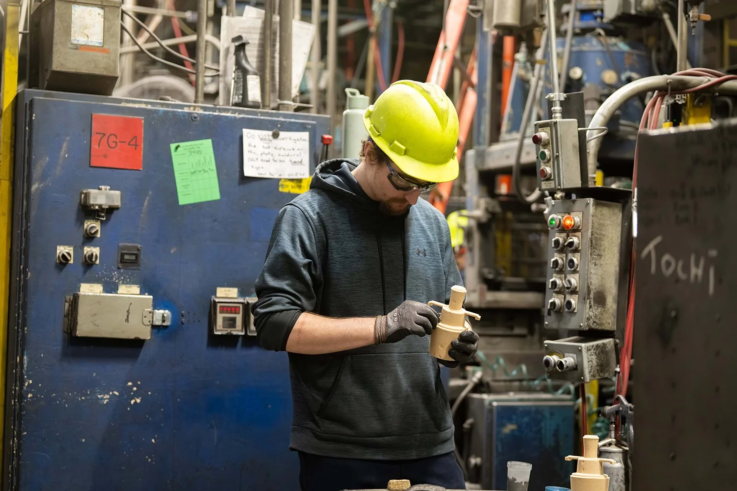 Manufacturing professional inspecting a finished casting during quality control.