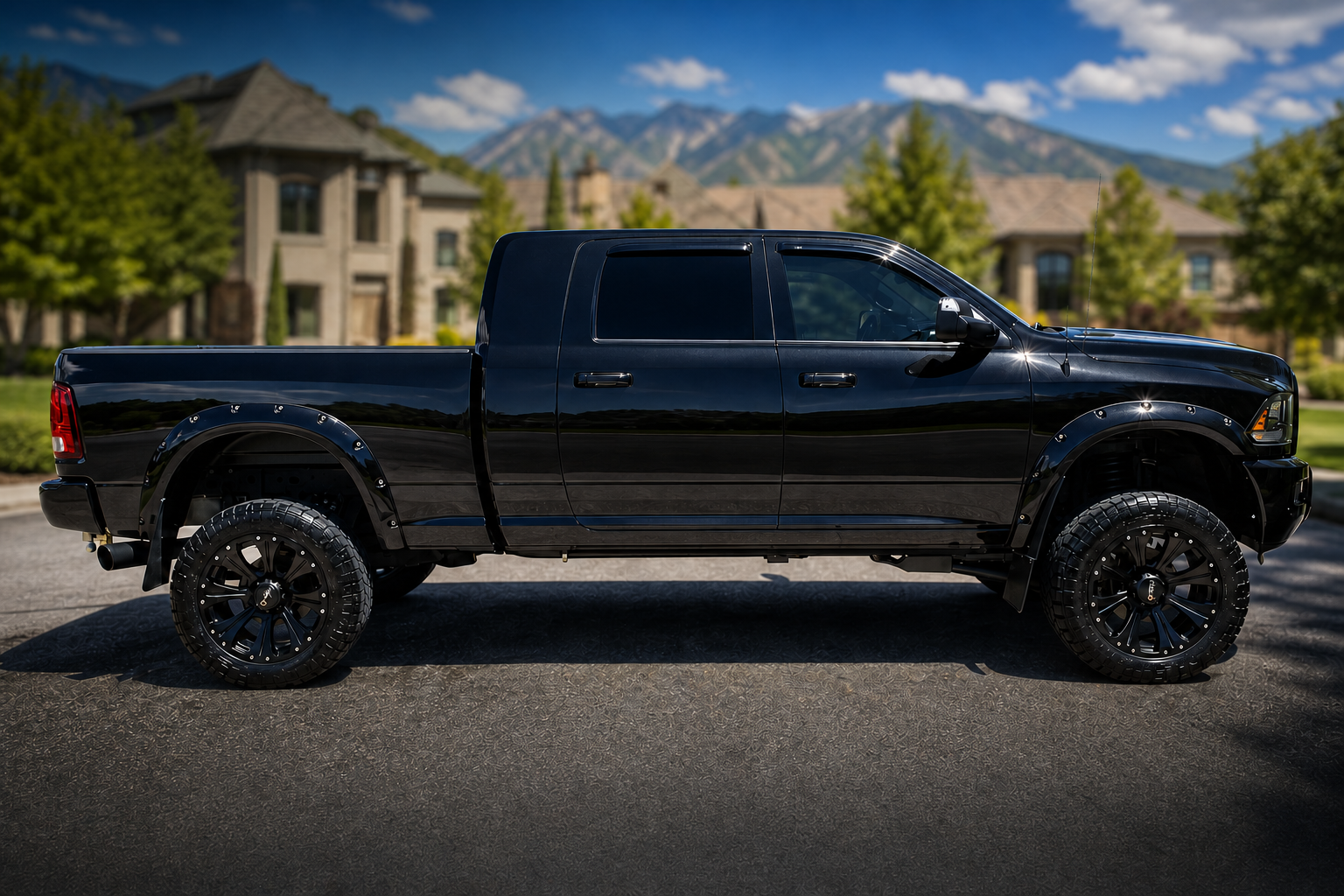 Blacked-out lifted Ram 2500 Heavy Duty with glossy paint and custom wheels after professional exterior detail — mobile car detailing service in Utah by Scrub Tub