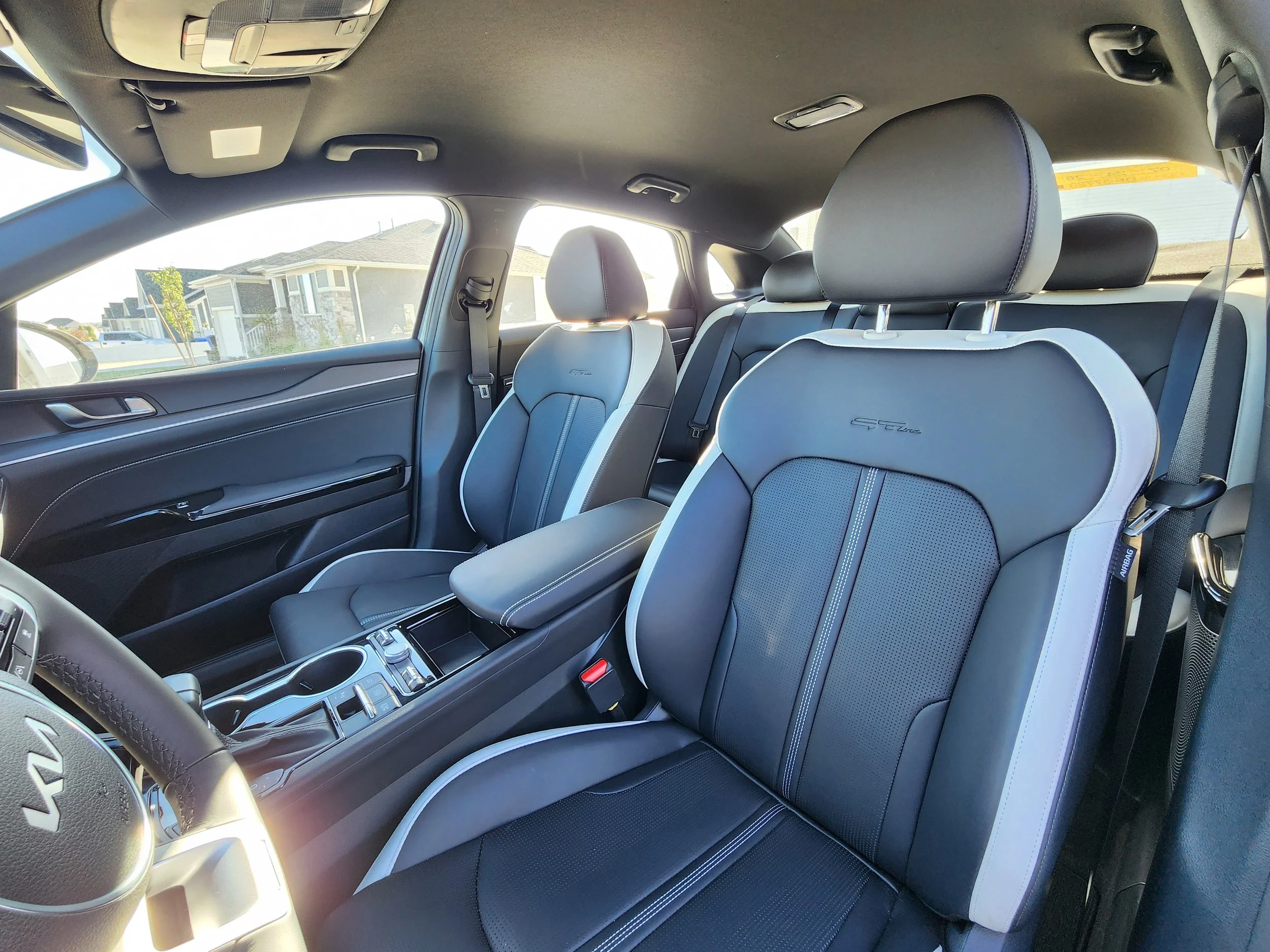 Freshly detailed black leather interior of a KIA K5 — professional mobile car detailing service in Utah by Scrub Tub