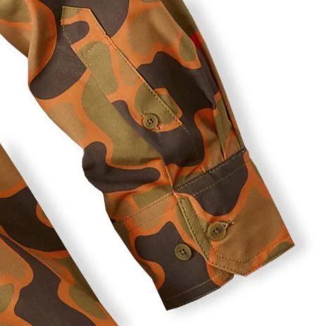 Close-up of a camouflage long sleeve shirt with a buttoned cuff.