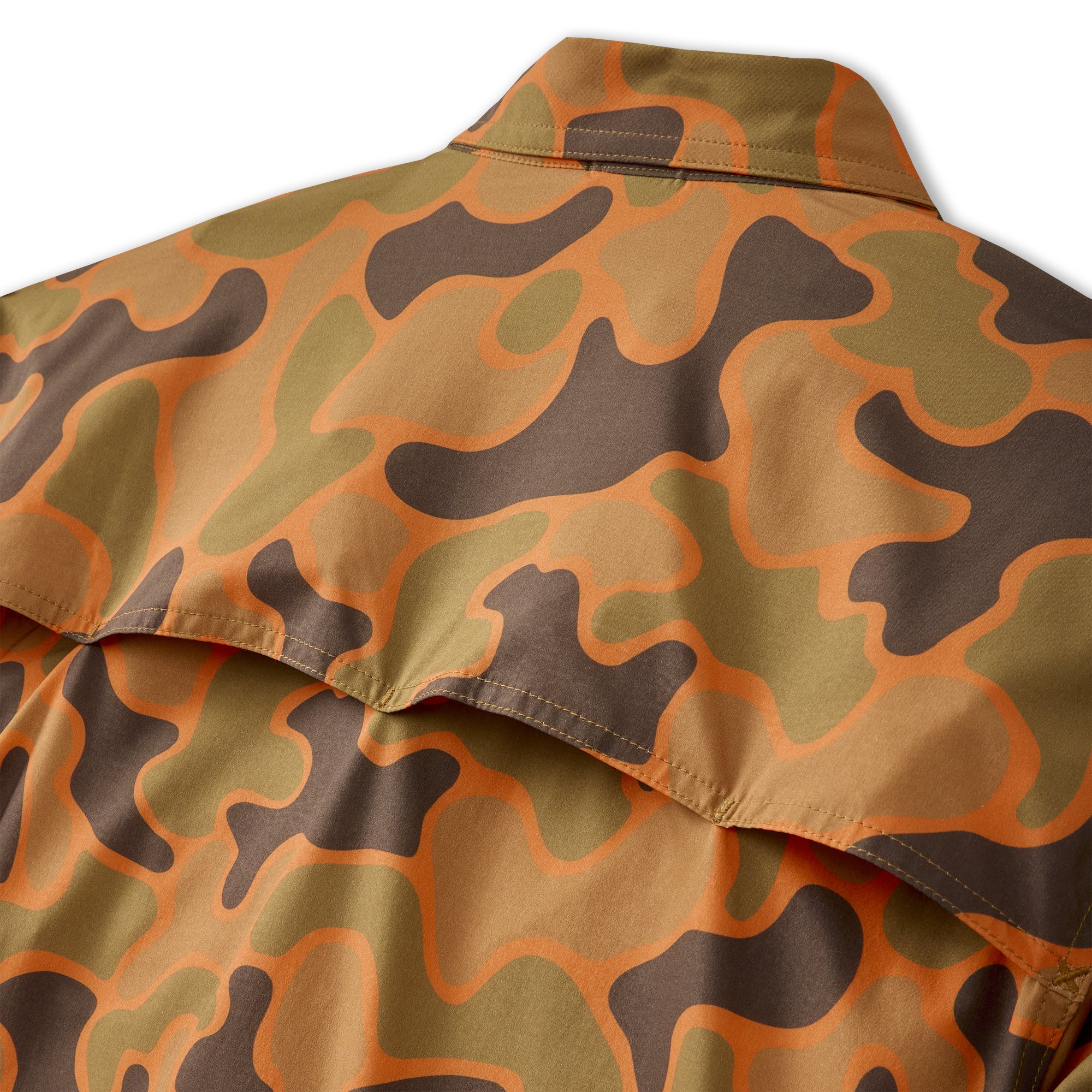 Close-up of fabric with a camouflage pattern in shades of brown, orange, and olive green, featuring a stitched hem and a collar.