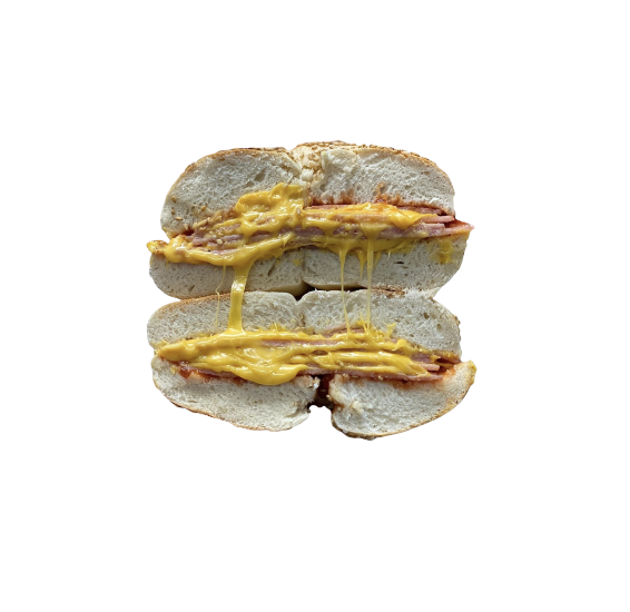 Close-up of a breakfast sandwich with eggs and bacon in a split bread bun.