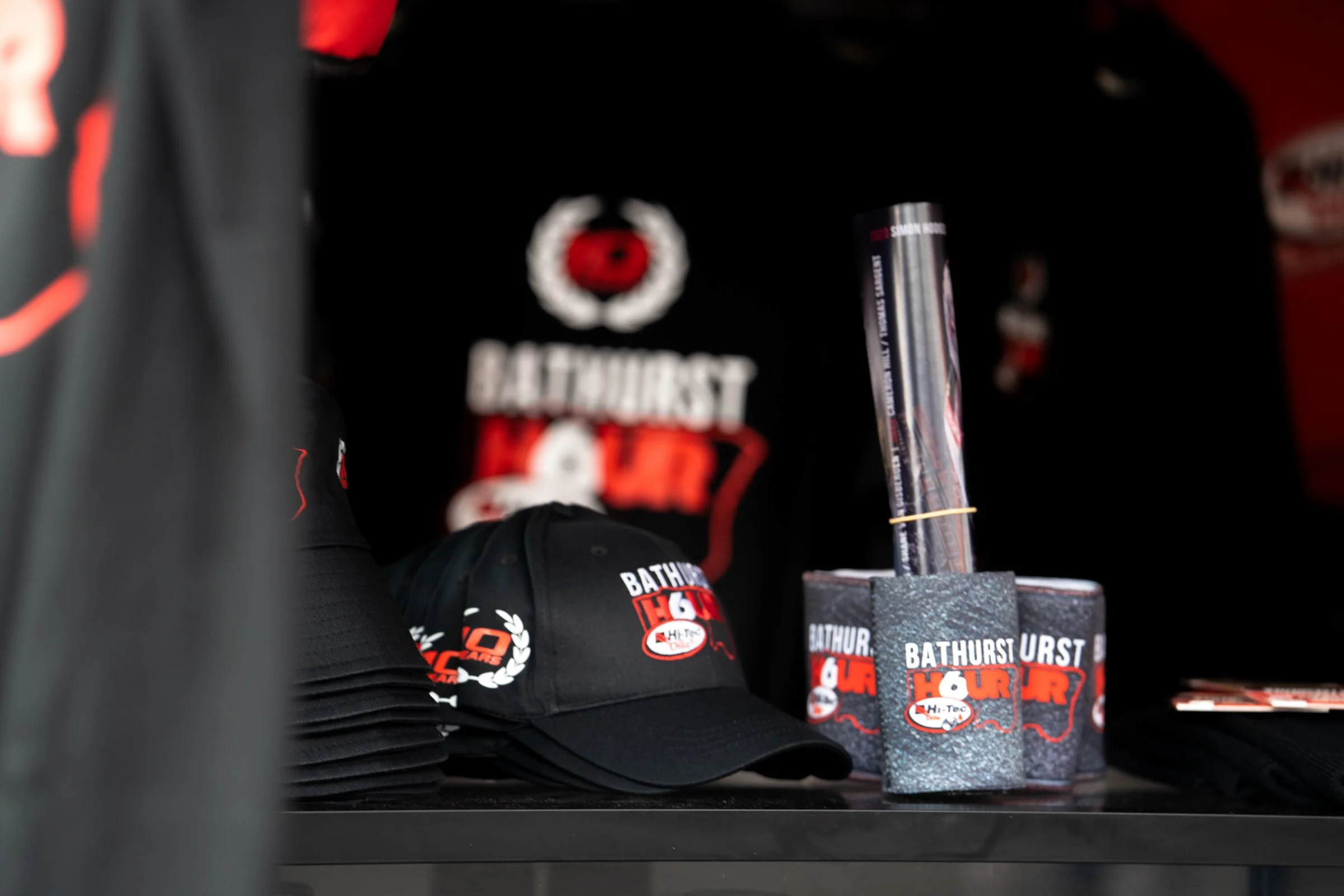 Black hats, clothing and drink holders displaying the Bathurst 6 Hour logo