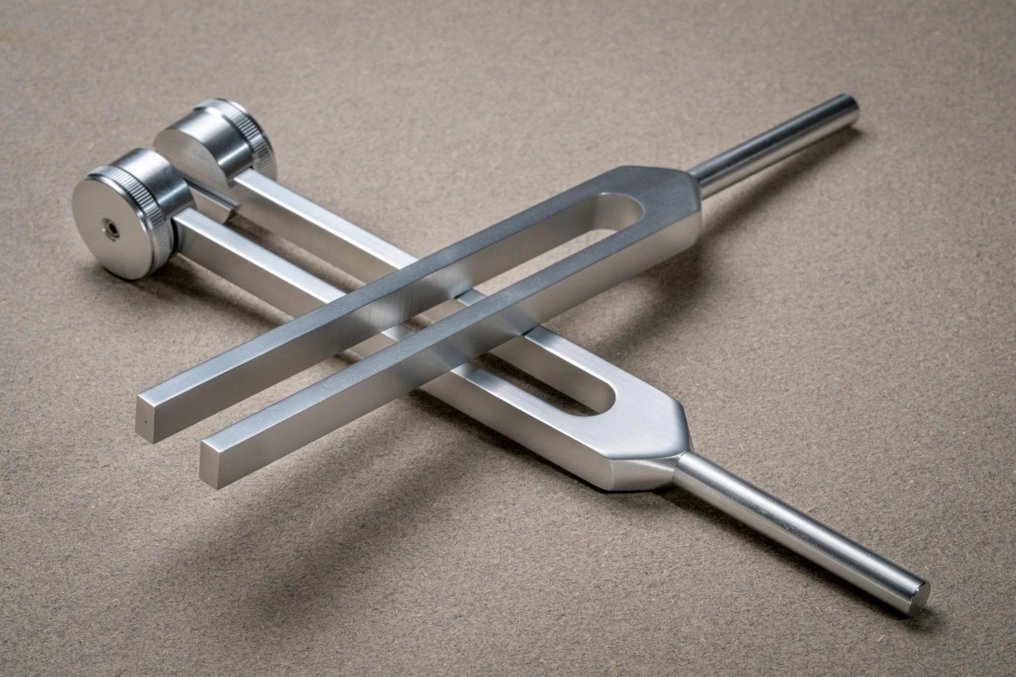 Weighted and unweighted Tuning forks displayed for tools used during the deeply soothing sound therapy session.