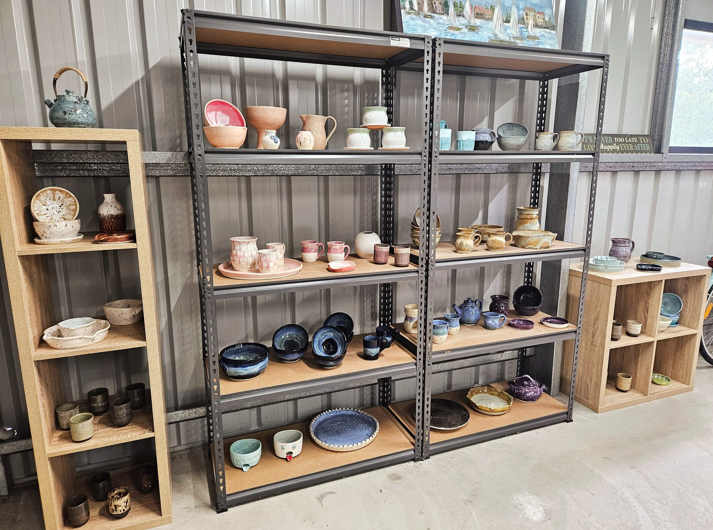 Collection of wheel-thrown pottery on display in a studio space