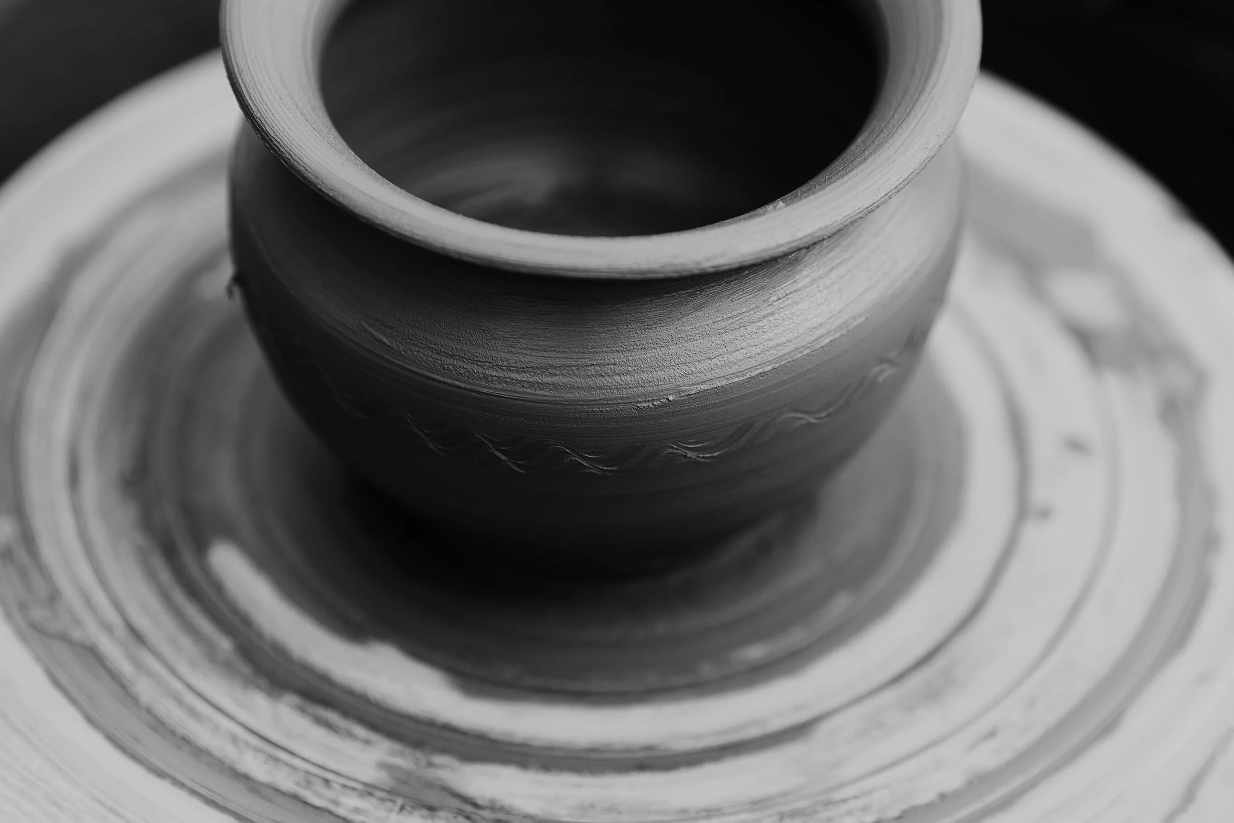 Clay being shaped on a pottery wheel during a workshop session