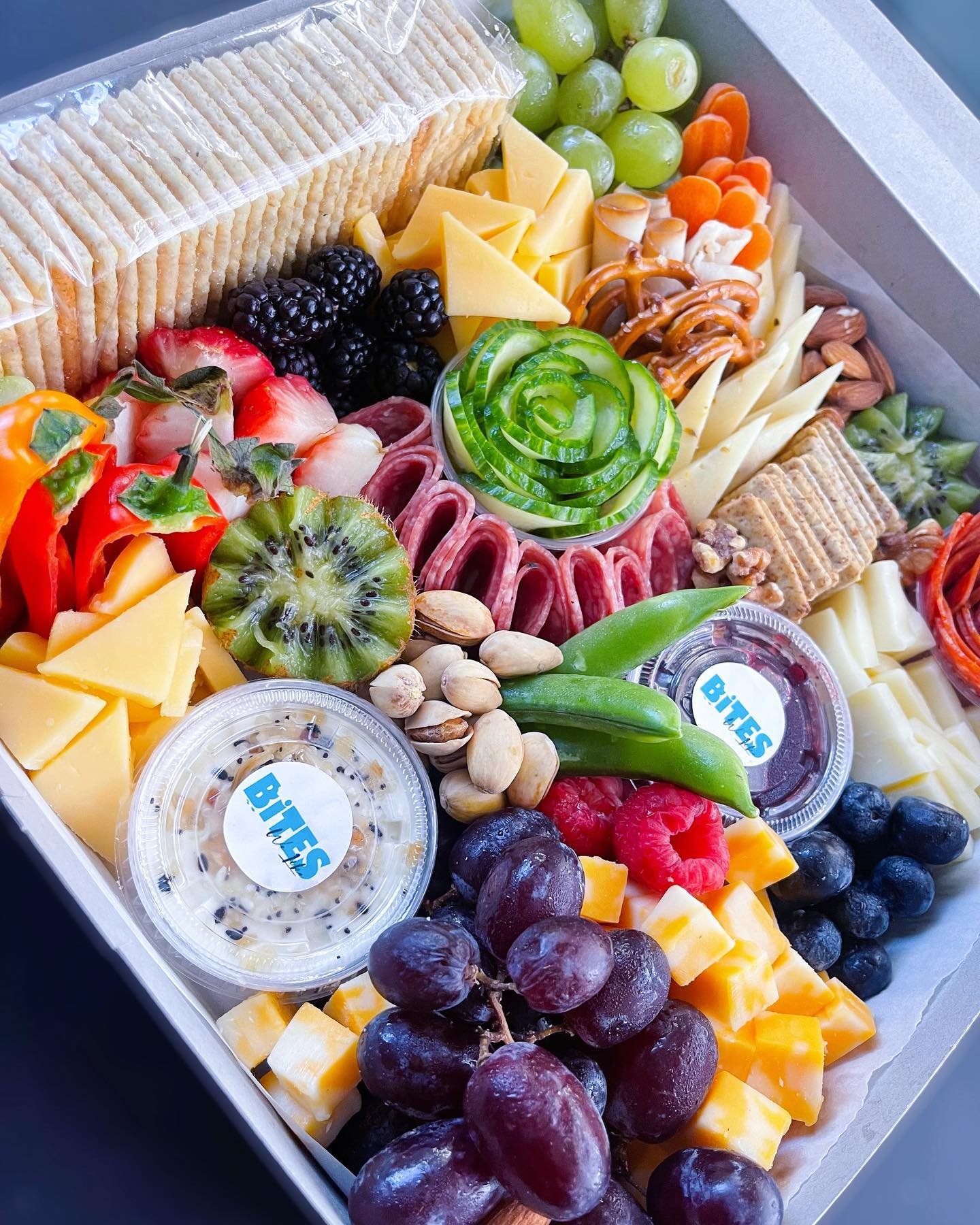 Luxury charcuterie graze box featuring cheeses, fruits, crackers, meats, nuts, and dips by Bites We Like in Nassau, Bahamas.