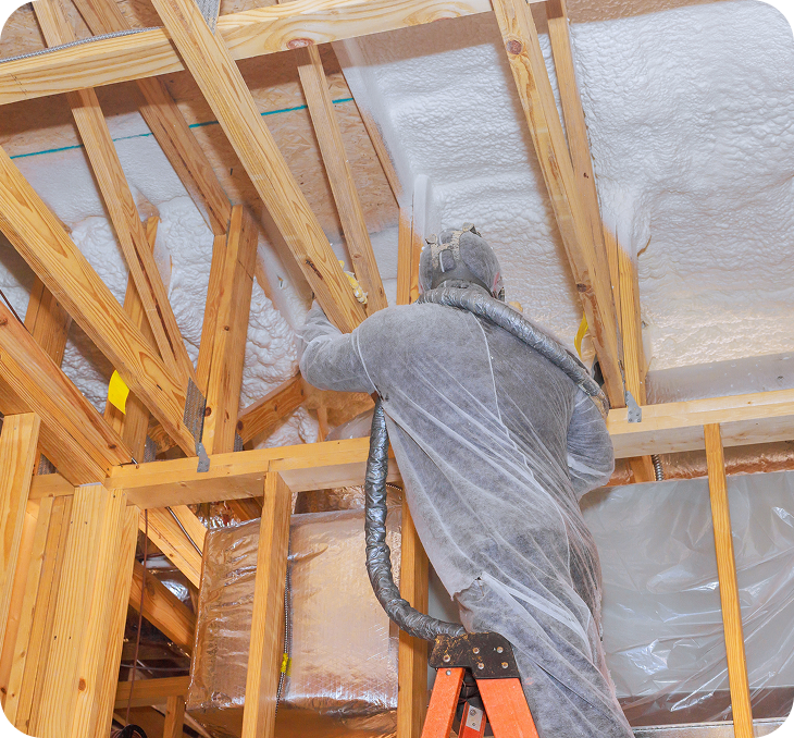 professional contractor applying spray foam insulation to residential attic professional contractor applying spray foam insulation to residential attic