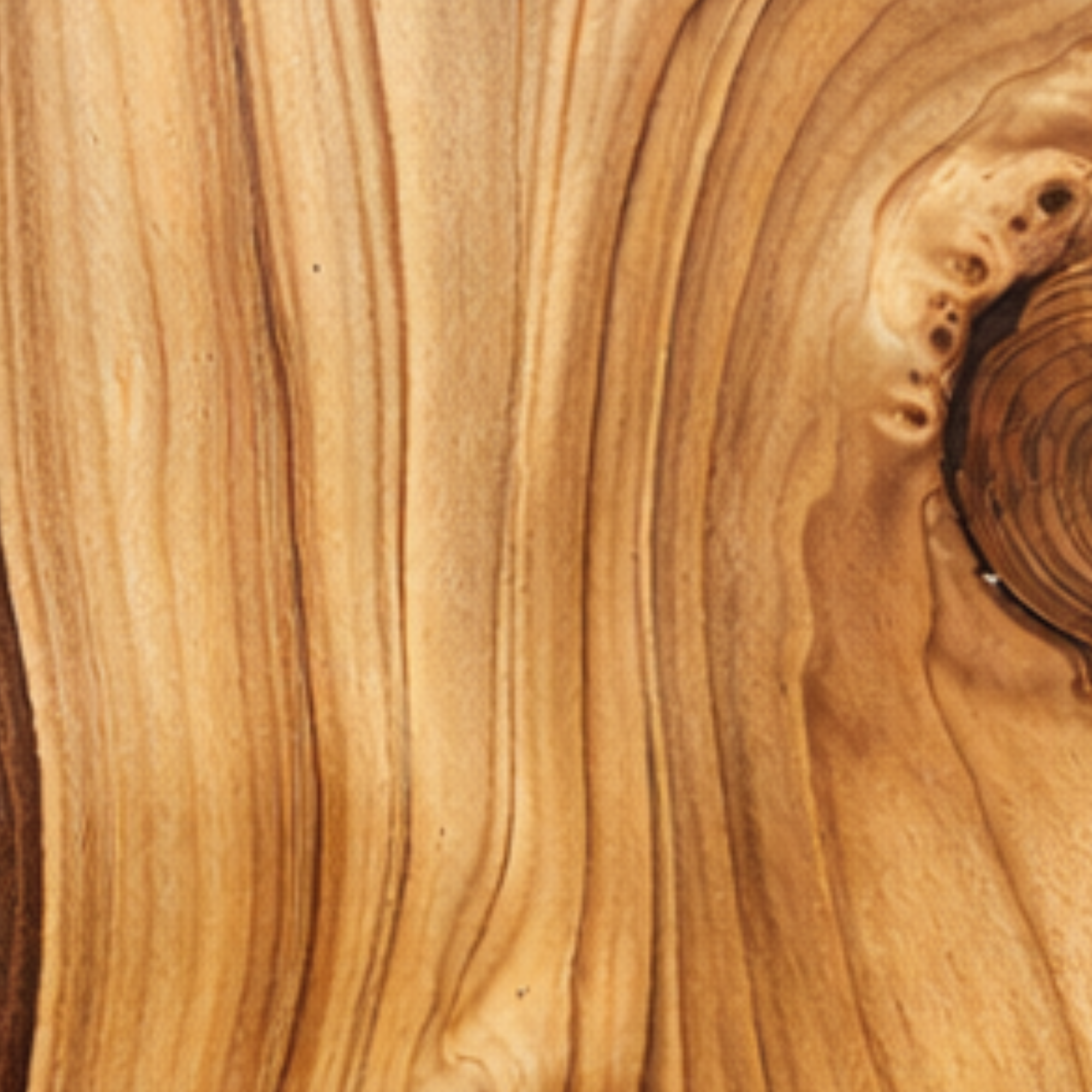 Close-up of a wooden surface with visible wood grain and natural color variations.