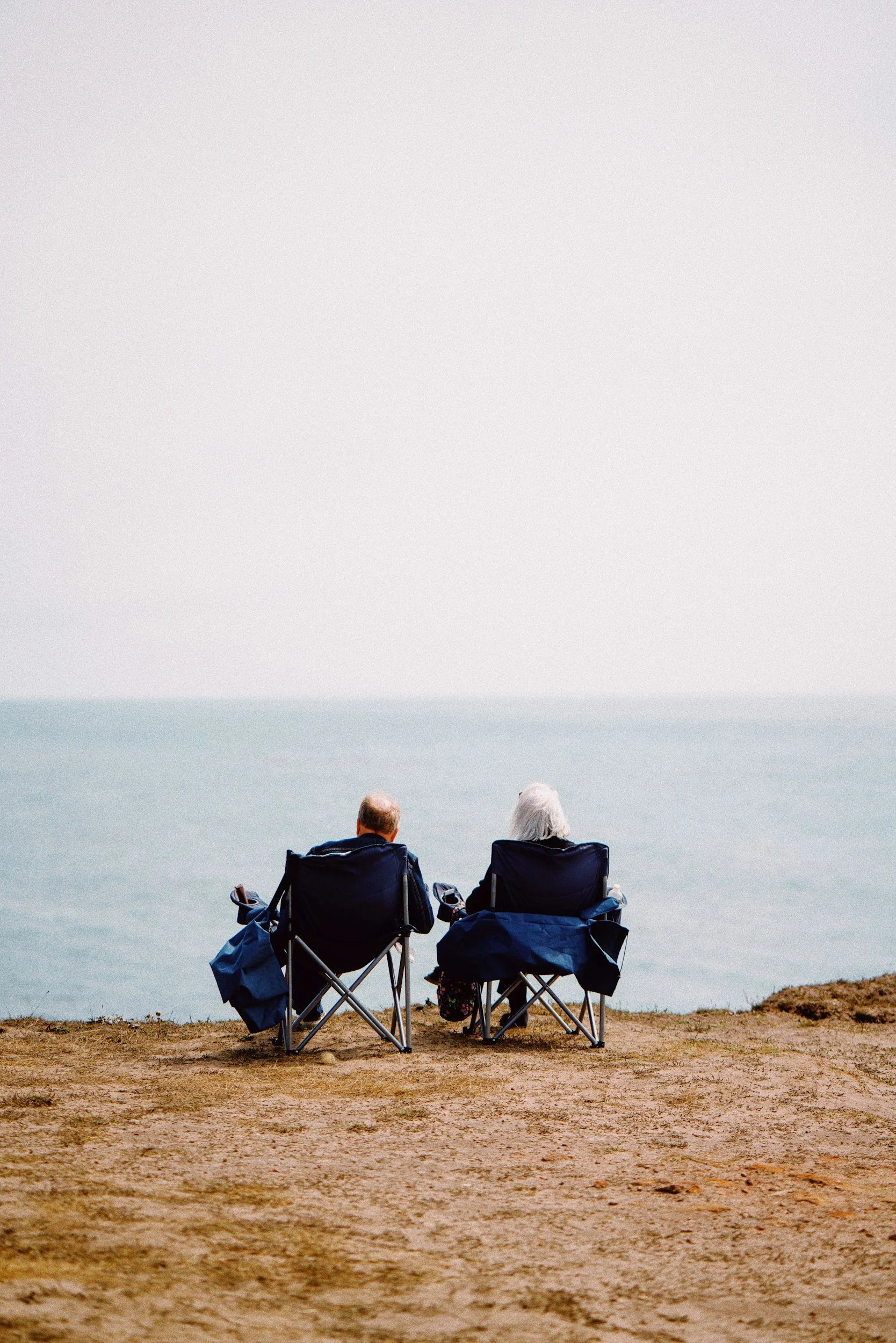 Couple on deck chairs at the beach
