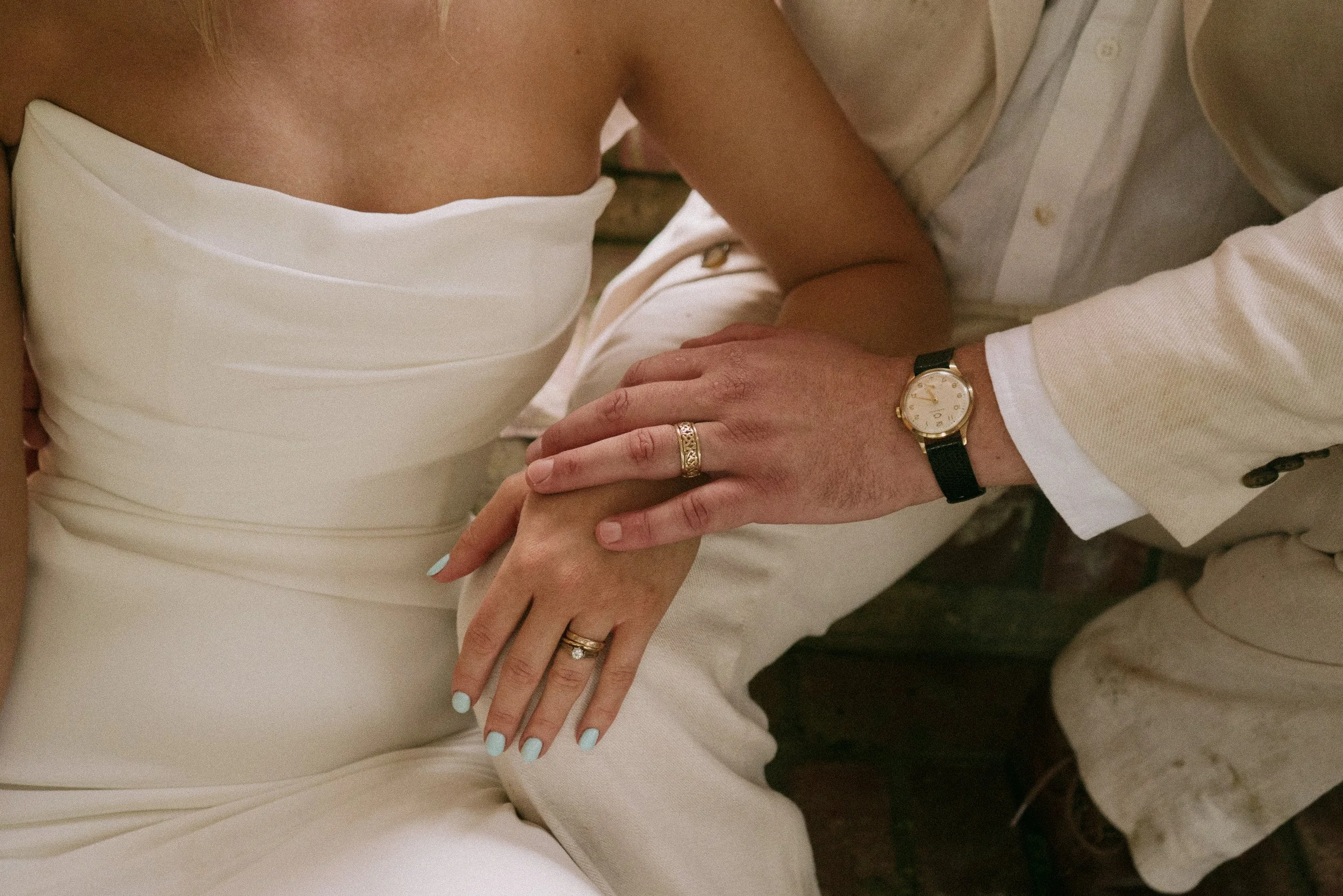 Married couples arms showing wedding rings