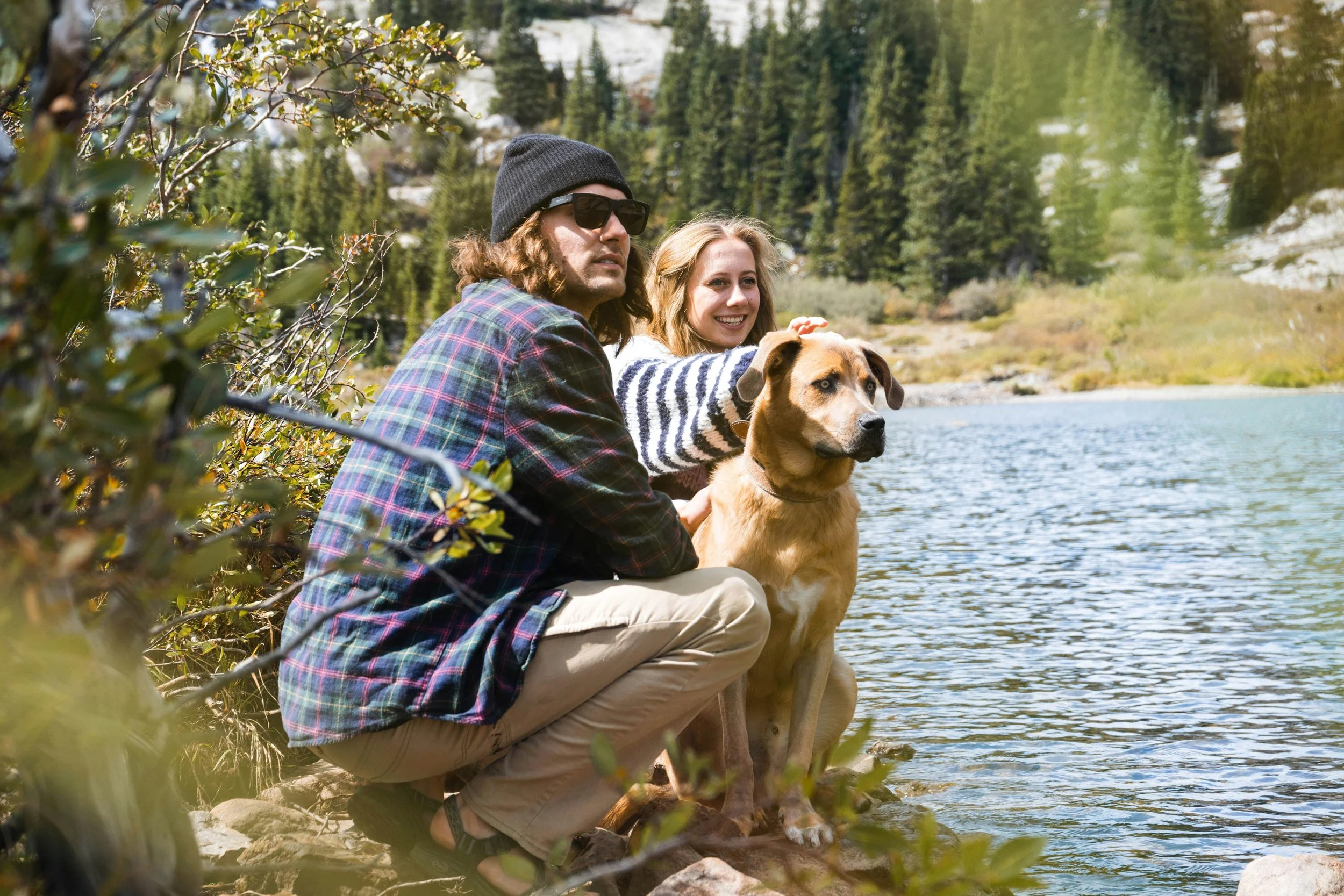 Young couple at the lake with their dog