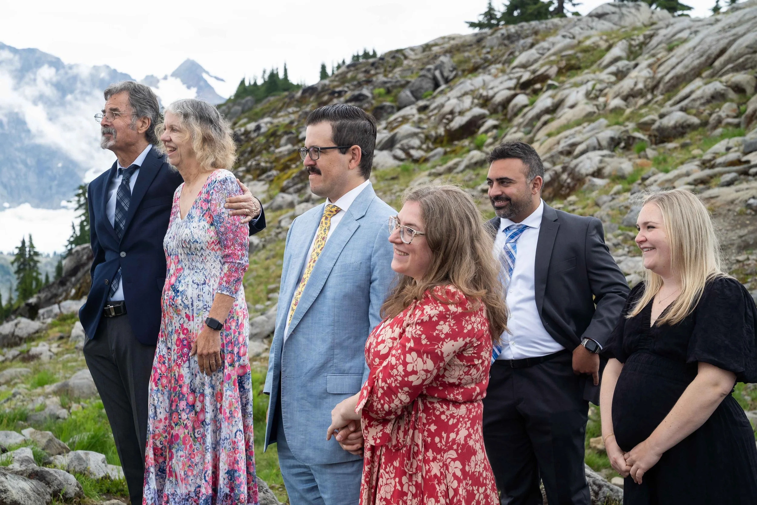 Photo of several couples including the bride and groom's parents and siblings watching their wedding ceremony at Artist Point, Washington.