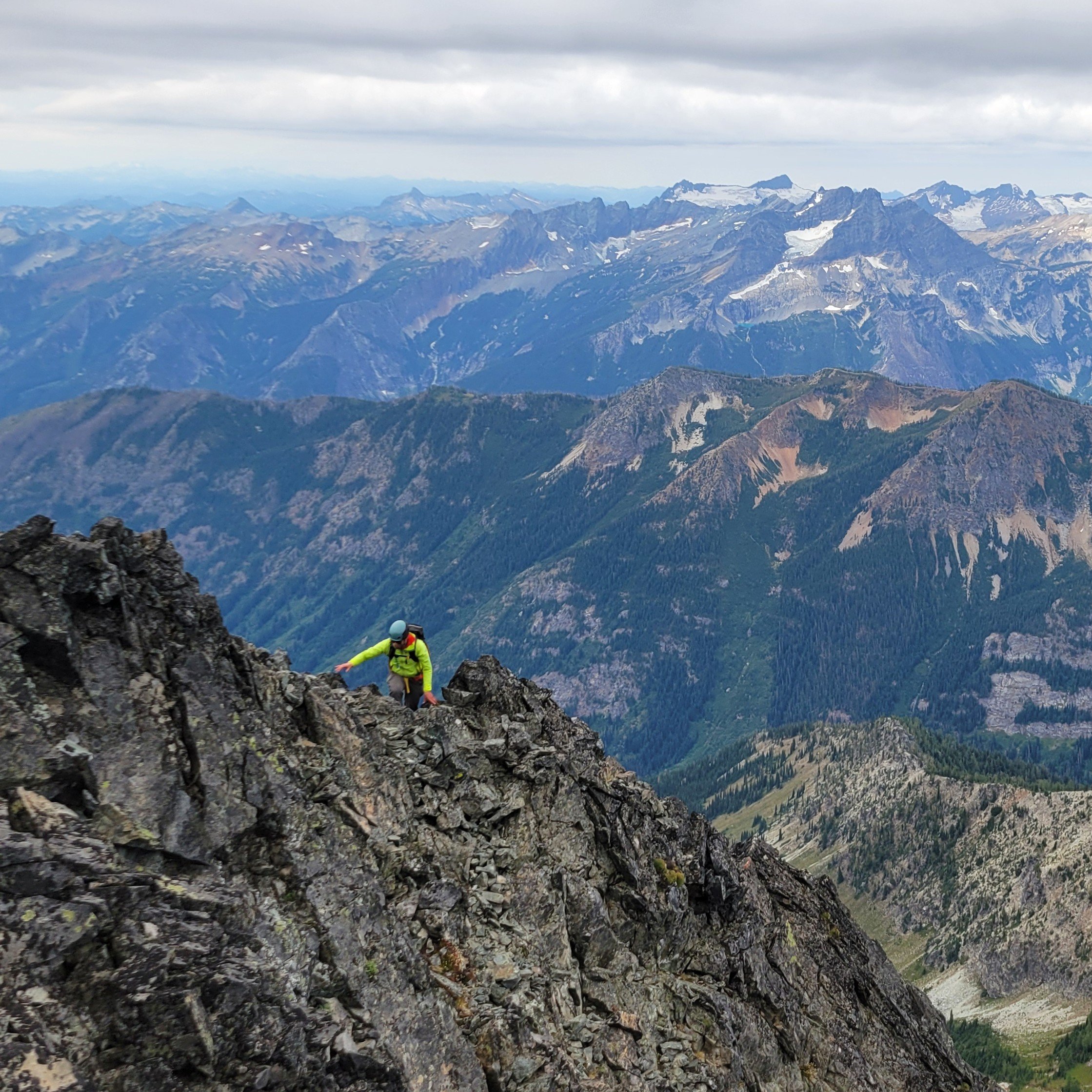 Michael, the photographer behind Wandering Sole Studios, scrambling in the Entiat Mountains in Washington. He is on a rocky summit ridge on Mt. Maude with the rest of the Entiats in the background.