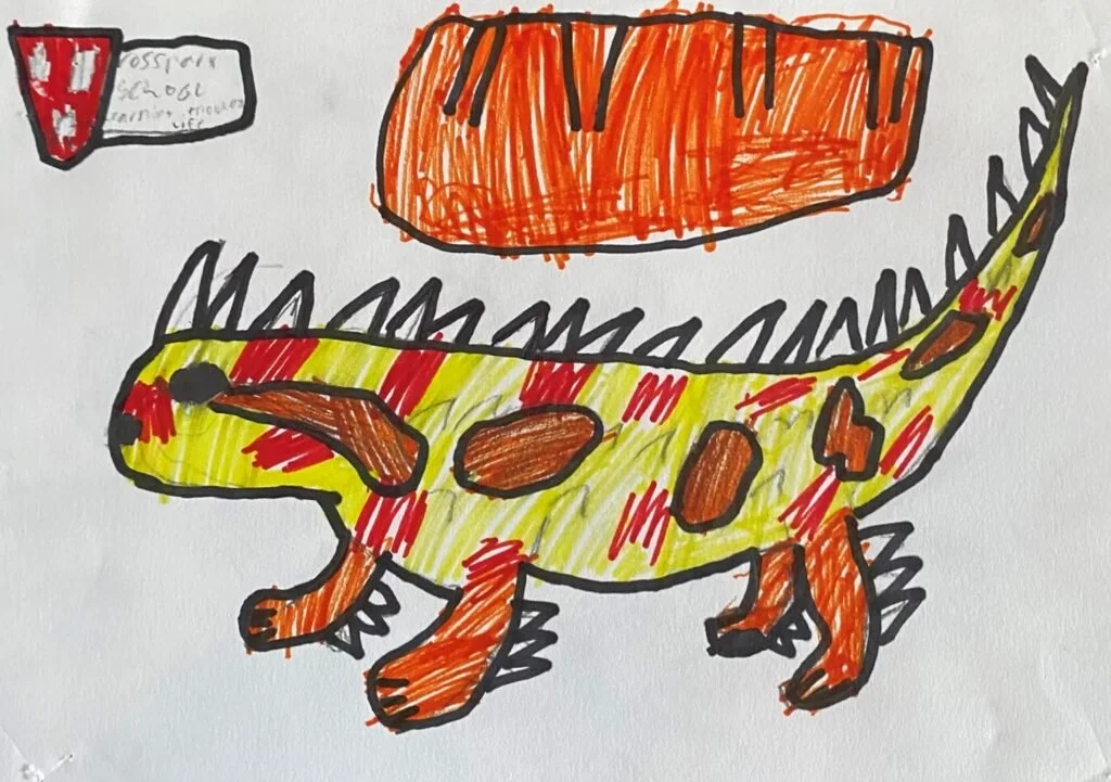 A colorful drawing of a dinosaur with a yellow body, orange spots, and black outlines, standing on four legs. There is an orange object above it and a small panel in the top left corner with some writing.