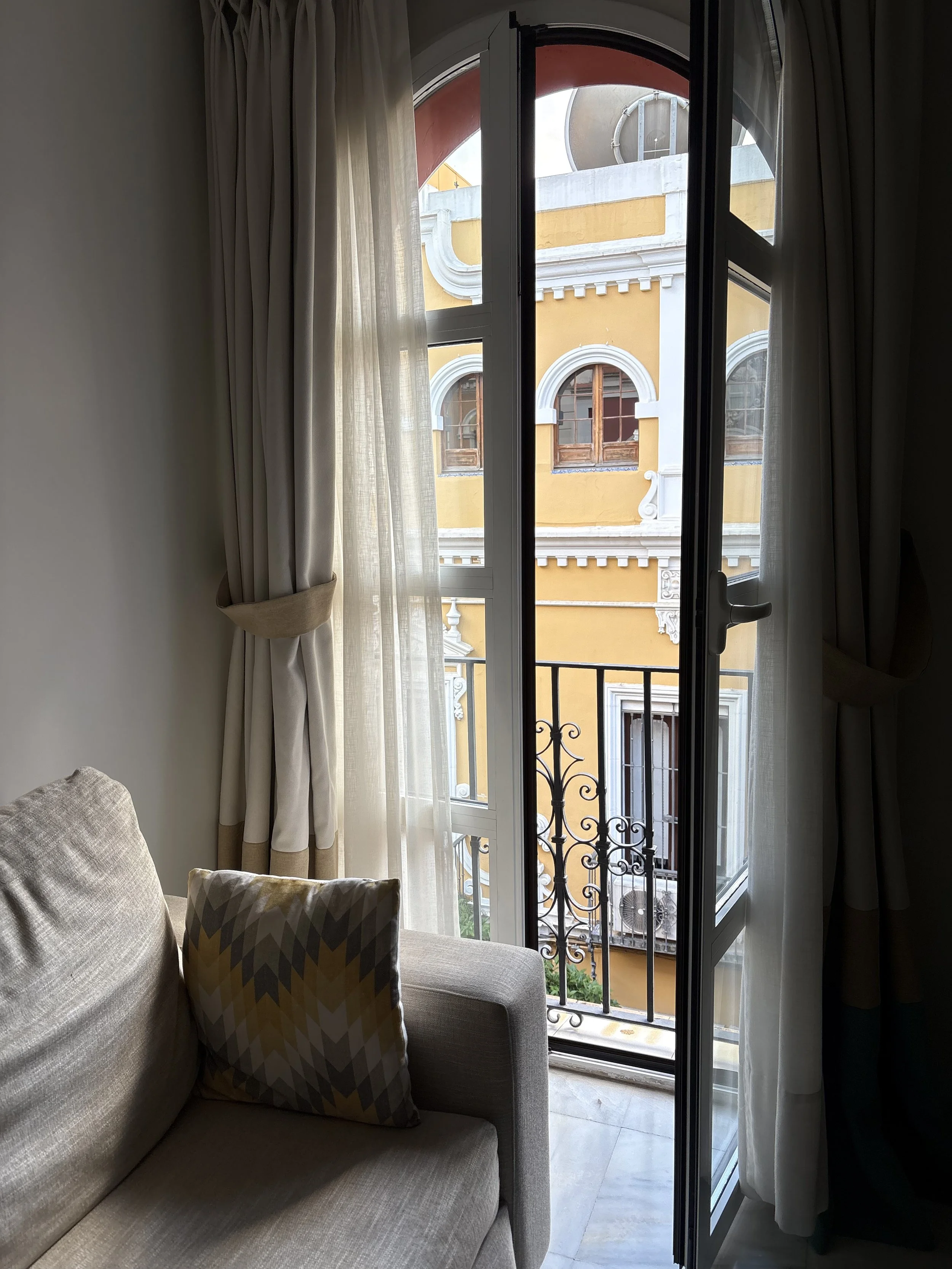 View from an apartment window of a lovely yellow building in Sevilla, Spain