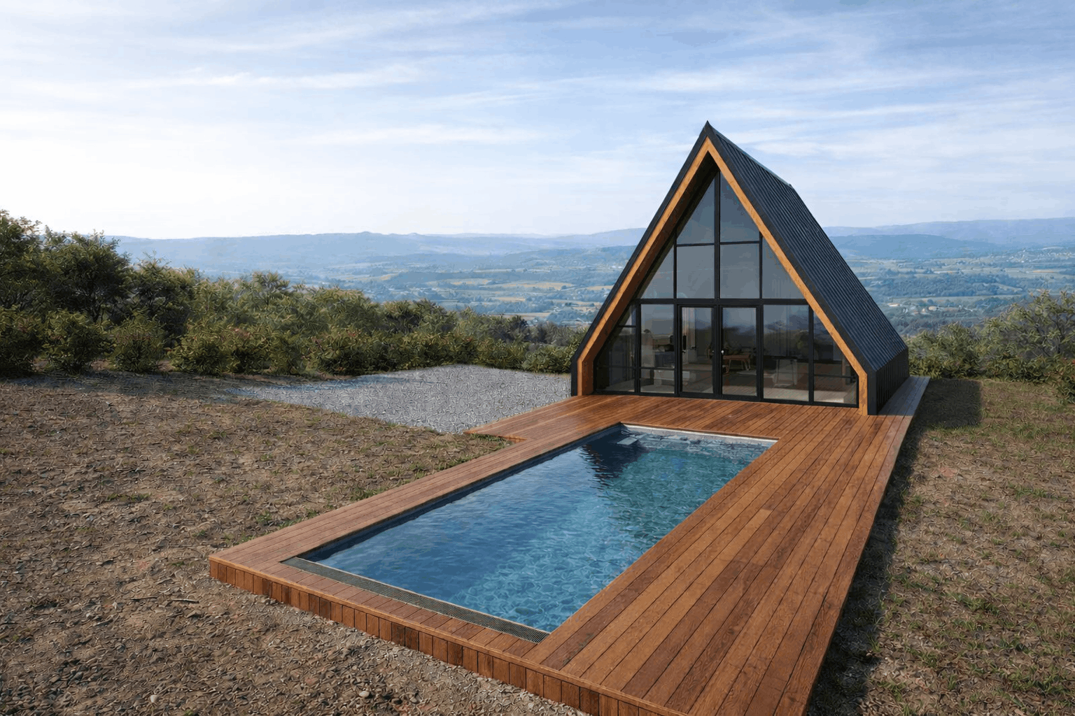 A modern A-frame house with a large glass front, situated on a hill with a wooden deck and a rectangular outdoor pool, overlooking a scenic valley with greenery and mountains in the background.