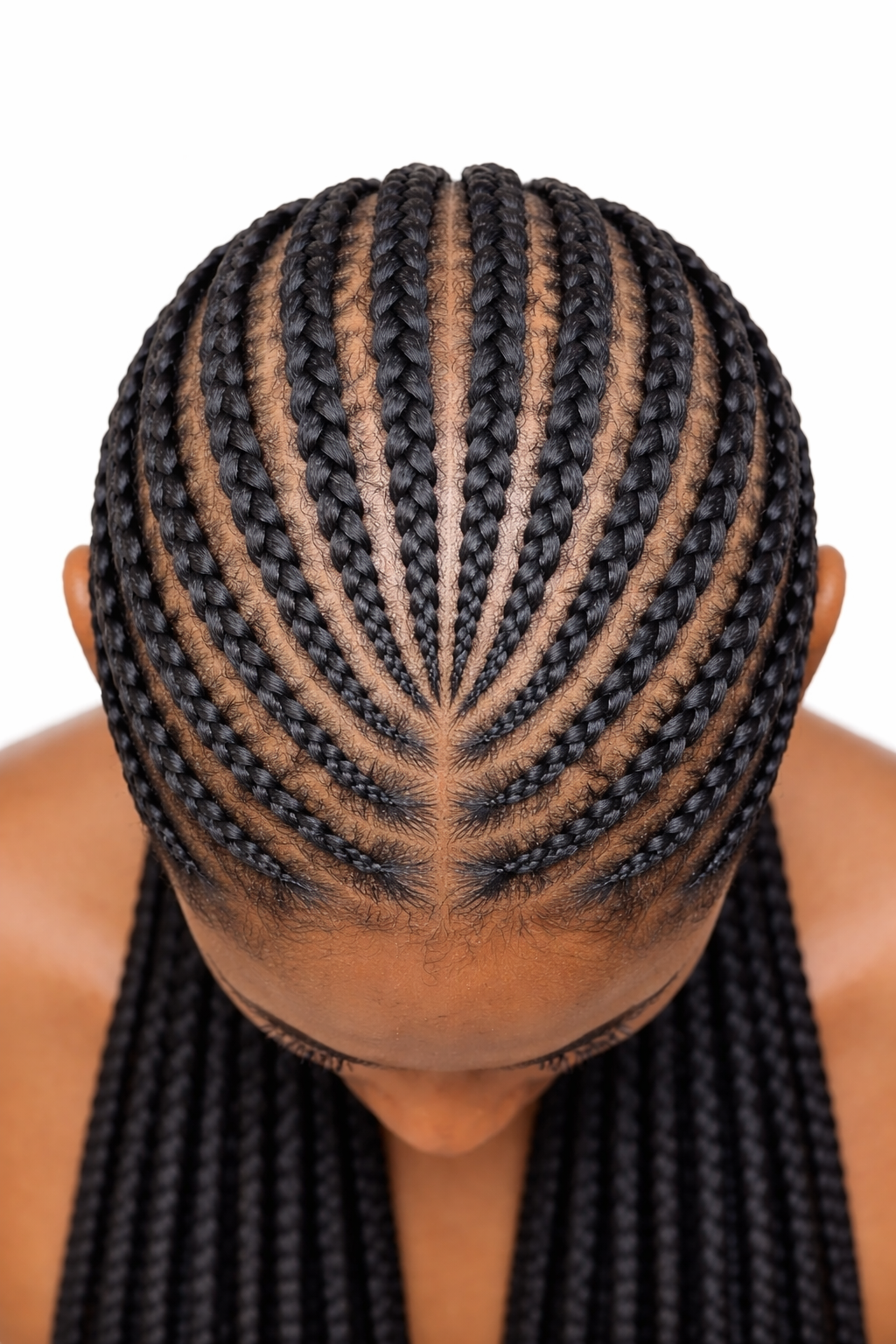 Close-up of a person's head showing intricate black braided hairstyles with a parting pattern on the scalp.